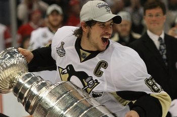 DETROIT - JUNE 12: Sidney Crosby #87 of the Pittsburgh Penguins holds the Stanley Cup following the Penguins victory over the Detroit Red Wings in Game Seven of the 2009 NHL Stanley Cup Finals at Joe Louis Arena on June 12, 2009 in Detroit, Michigan.  (Ph