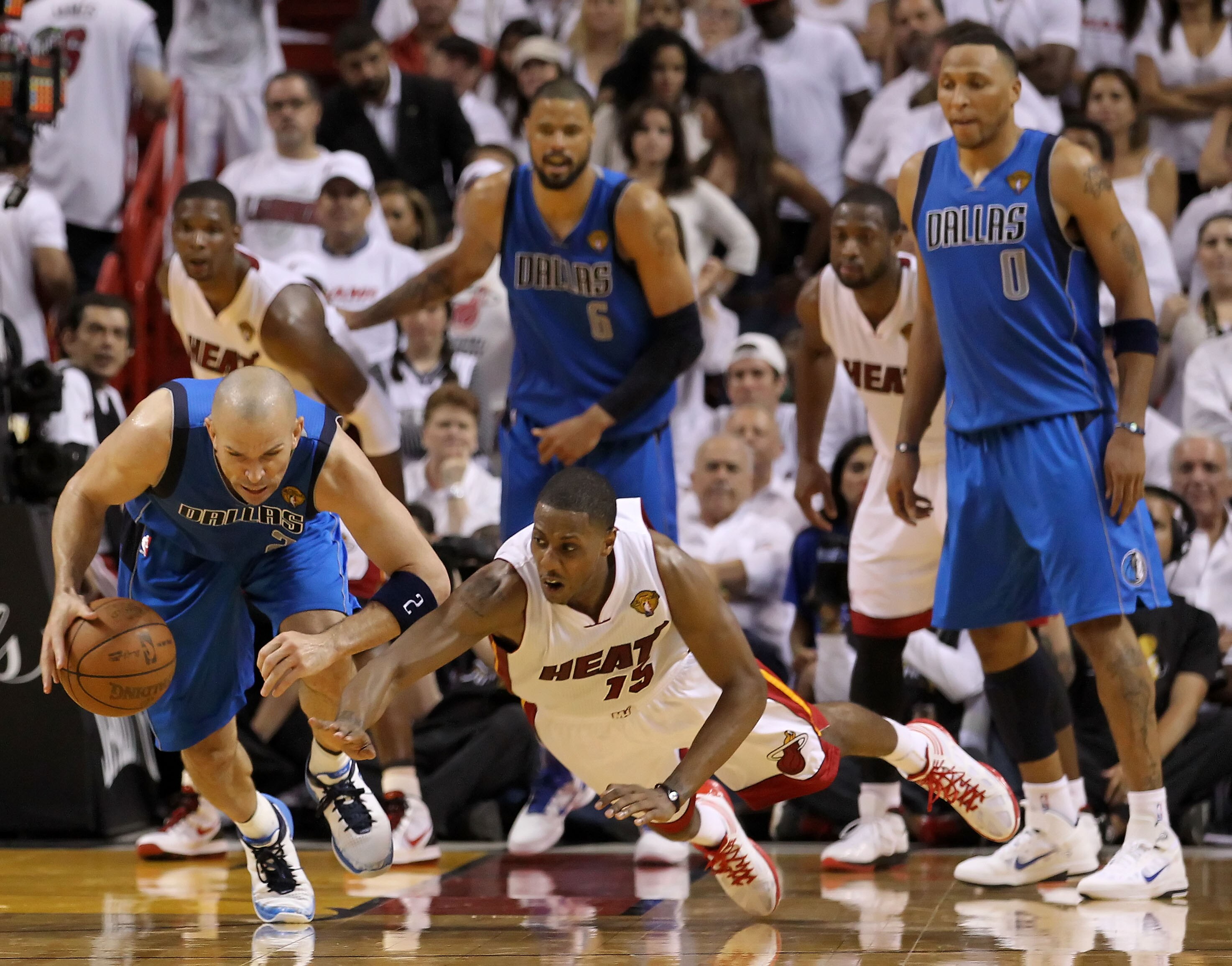 MIAMI, FL - JUNE 12:  Jason Kidd #2 of the Dallas Mavericks controls a loose ball against Mario Chalmers #15 of the Miami Heat in Game Six of the 2011 NBA Finals at American Airlines Arena on June 12, 2011 in Miami, Florida. The Mavericks won 105-95. NOTE