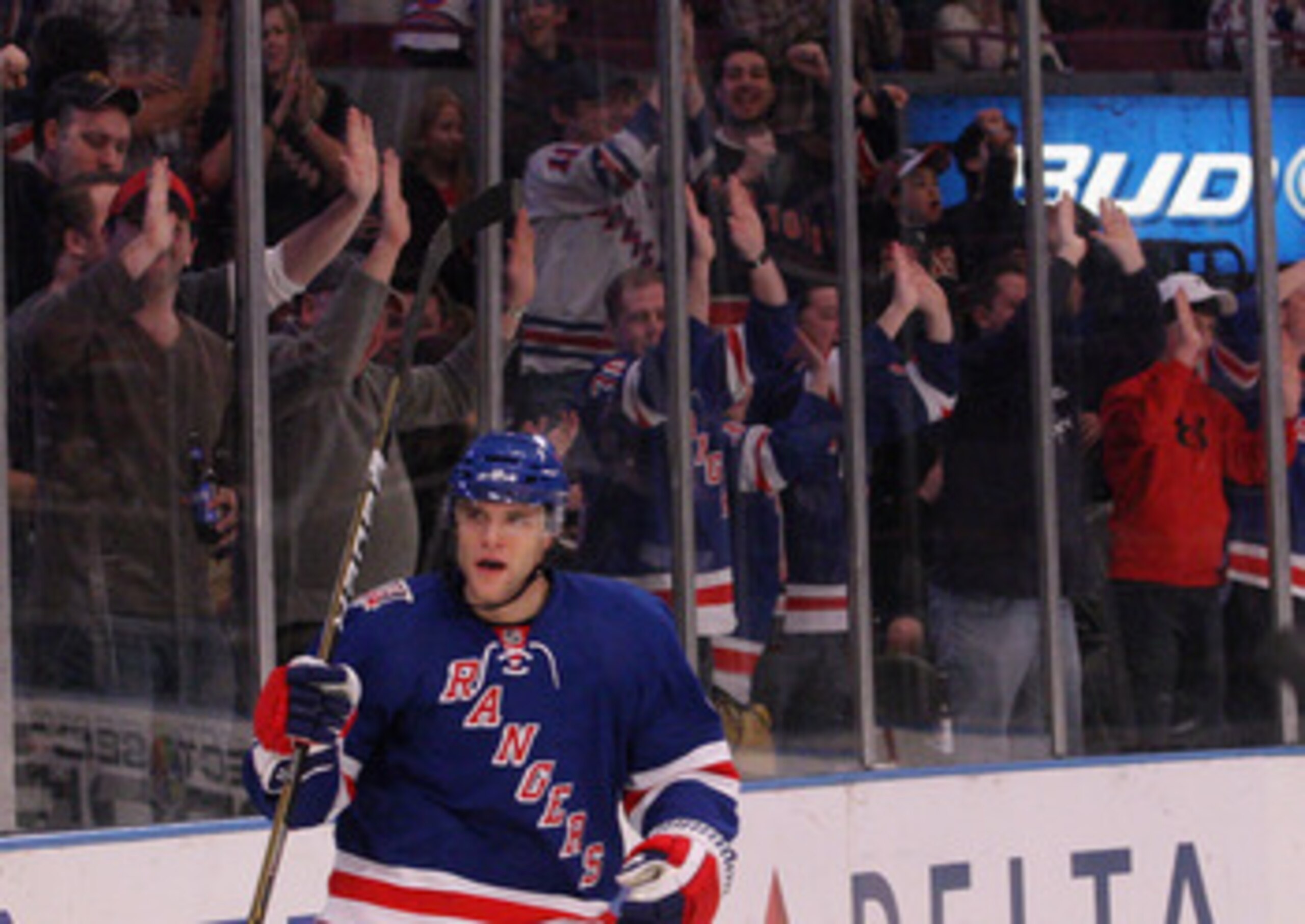 NEW YORK, NY - APRIL 09: Michael Sauer #38 of the New York Rangers celebrates a second period goal by Wojtek Wolski #86 (not shown) against the New Jersey Devils at Madison Square Garden on April 9, 2011 in New York City. The Rangers defeated the Devils 5