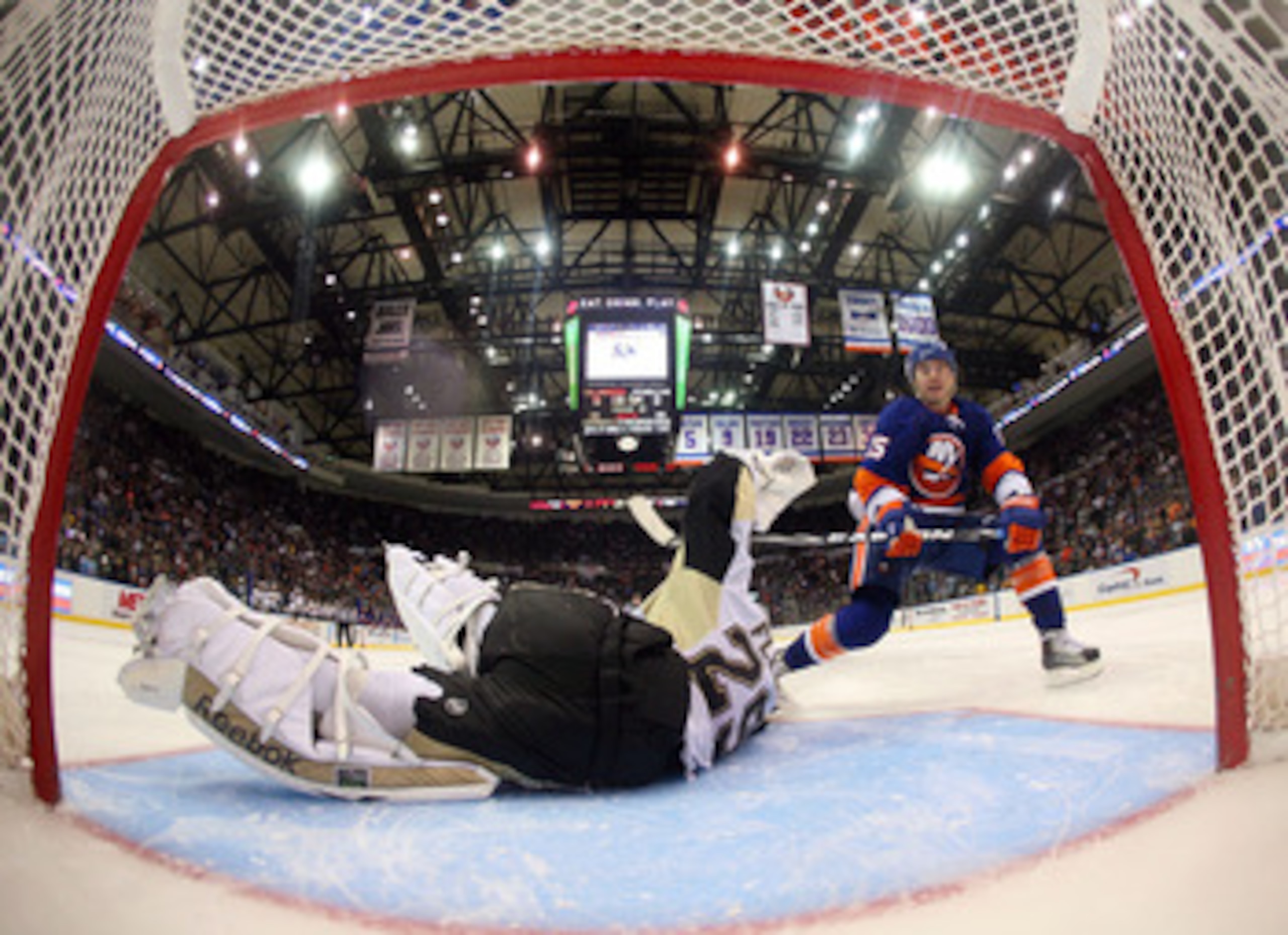 UNIONDALE, NY - APRIL 08: Marc-Andre Fleury #29 of the Pittsburgh Penguins stops P.A. Parenteau #15 of the New York Islanders during teh shootout at the Nassau Coliseum on April 8, 2011 in Uniondale, New York. The Penguins defeated the Islanders 4-3 in th