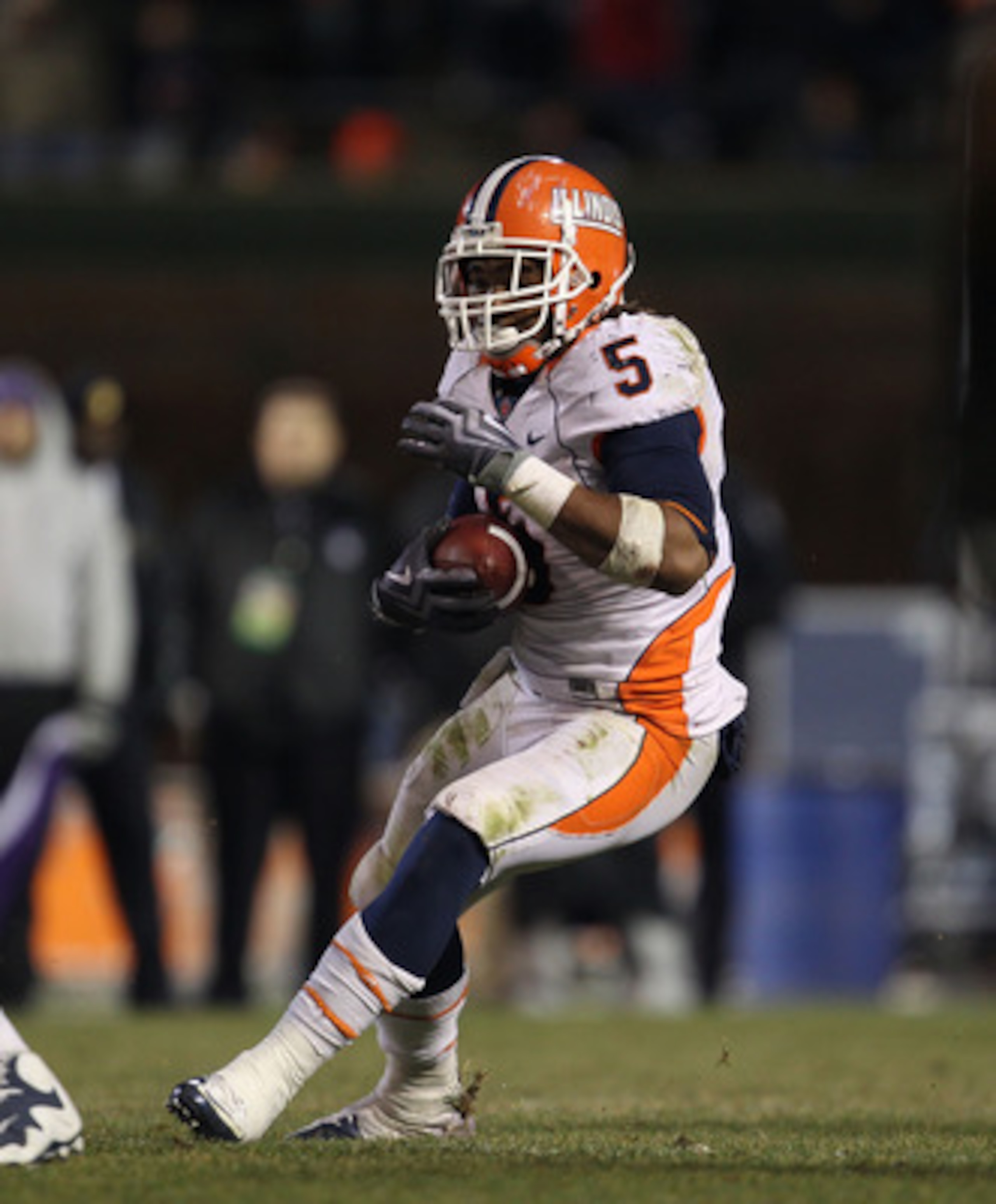 CHICAGO, IL - NOVEMBER 20: Mikel Leshoure #5 of the Illinois Fighting Illini runs against the Northwestern Wildcats closes in during a game played at Wrigley Field on November 20, 2010 in Chicago, Illinois. Illinois defeated Northwestern 48-27. (Photo by 