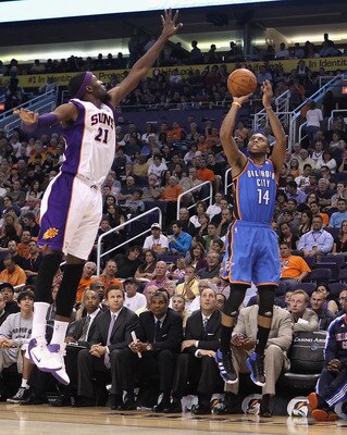 PHOENIX, AZ - MARCH 30:  Daequan Cook #14 of the Oklahoma City Thunder puts up a shot during the NBA game against the Phoenix Suns at US Airways Center on March 30, 2011 in Phoenix, Arizona. The Thunder defeated the Suns 116-98.   NOTE TO USER: User expre