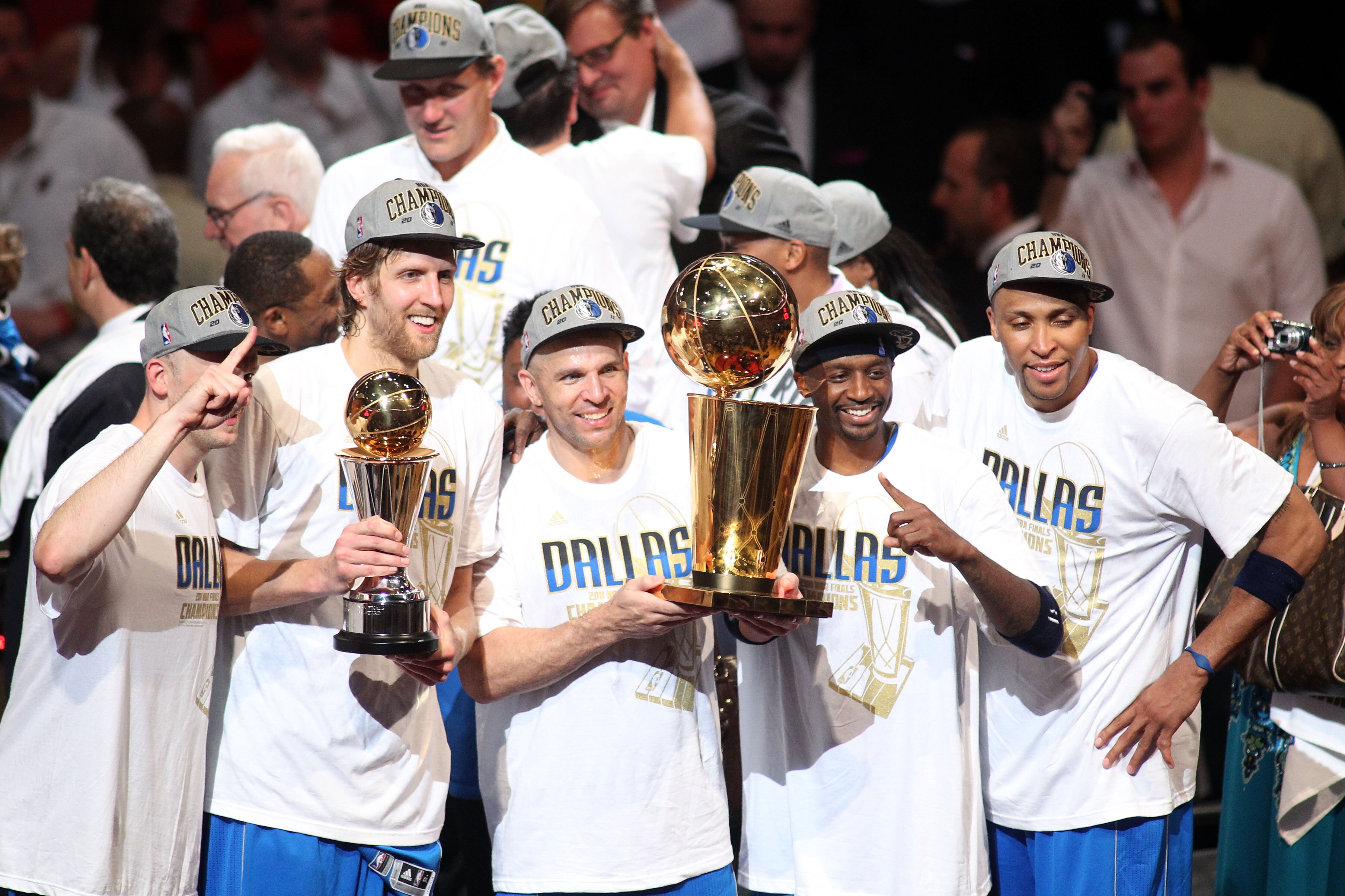 MIAMI, FL - JUNE 12:  (L-R) Brian Cardinal #35, Finals MVP Dirk Nowitzki #41, Jason Kidd #2, Jason Terry #31 and Shawn Marion #0 of the Dallas Mavericks celebrate with the Larry O'Brien trophy after they won 105-95 against the Miami Heat in Game Six of th