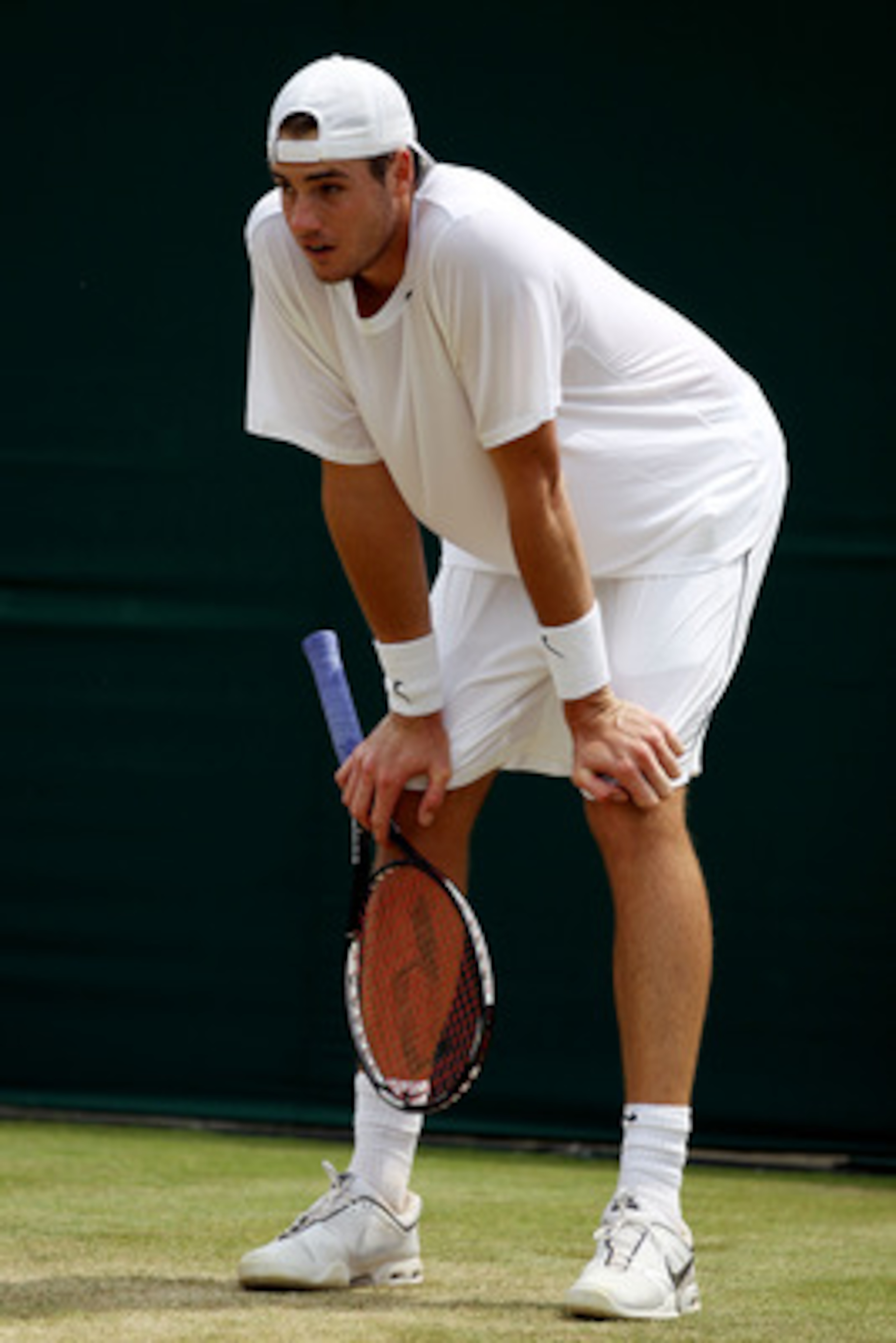 LONDON, ENGLAND - JUNE 25:  John Isner of USA rests during his match against Thiemo De Bakker of Netherlands on Day Five of the Wimbledon Lawn Tennis Championships at the All England Lawn Tennis and Croquet Club on June 25, 2010 in London, England.  (Phot