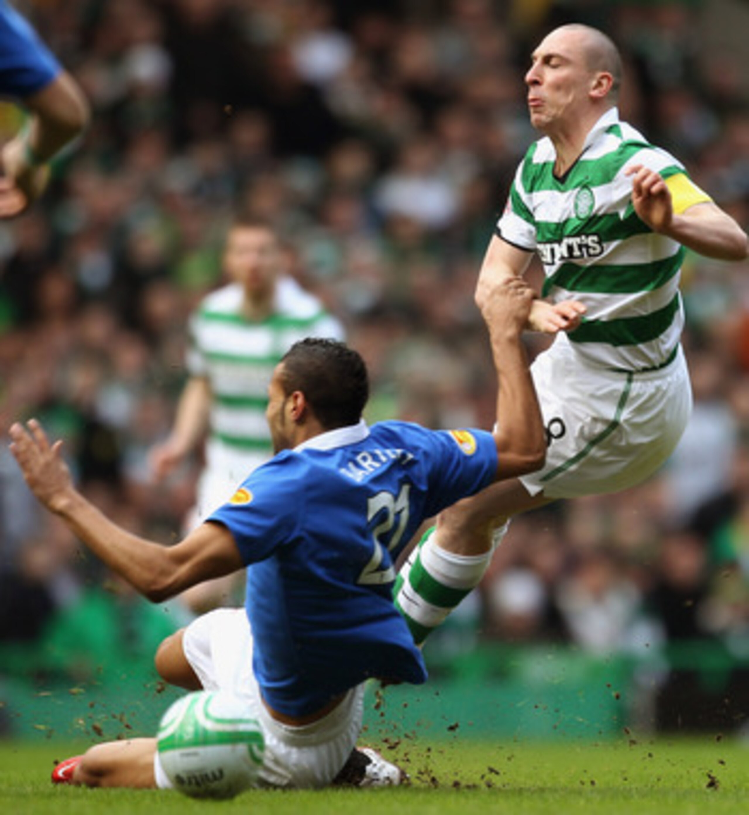 GLASGOW, SCOTLAND - FEBRUARY 20:  Scott Brown of Celtic is tackled by Kyle Bartley of Rangers during the Clydesdale Bank Premier League match between Celtic and Rangers at Celtic Park on February 20, 2011 in Glasgow, Scotland..  (Photo by Jeff J Mitchell/