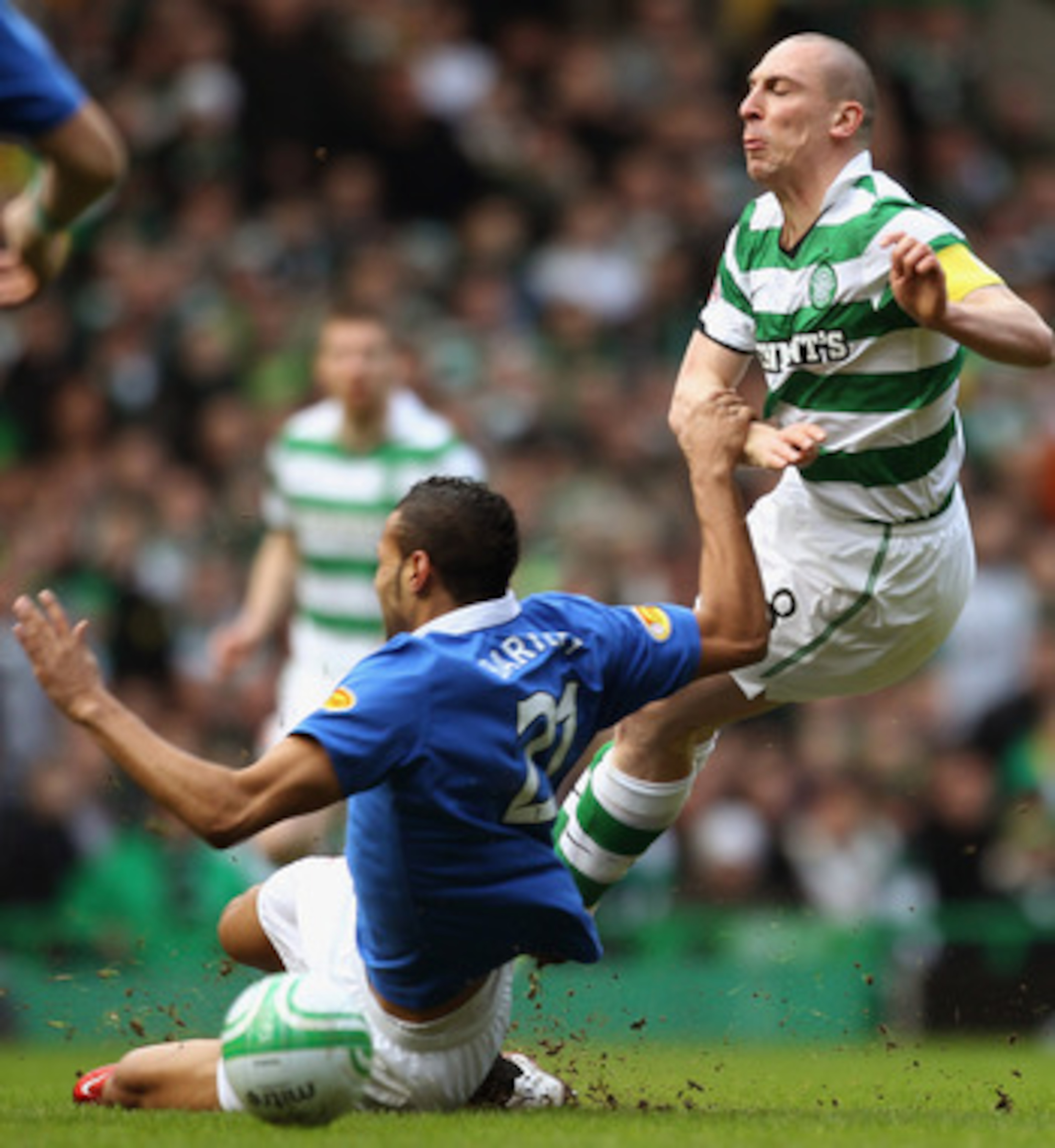 GLASGOW, SCOTLAND - FEBRUARY 20:  Scott Brown of Celtic is tackled by Kyle Bartley of Rangers during the Clydesdale Bank Premier League match between Celtic and Rangers at Celtic Park on February 20, 2011 in Glasgow, Scotland..  (Photo by Jeff J Mitchell/