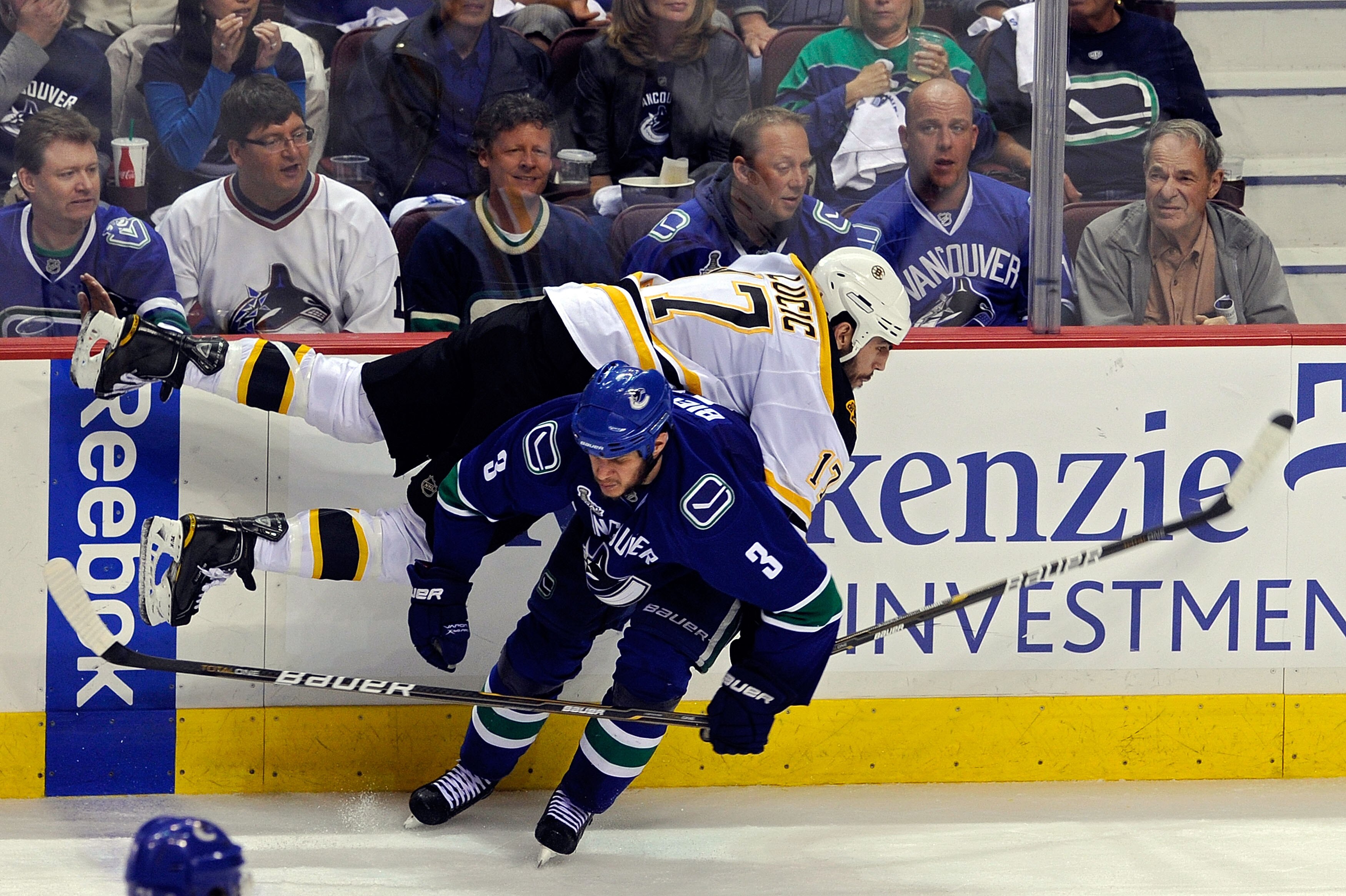 VANCOUVER, BC - JUNE 10:  Milan Lucic #17 of the Boston Bruins gets checked by Kevin Bieksa #3 of the Vancouver Canucks during Game Five of the 2011 NHL Stanley Cup Final at Rogers Arena on June 10, 2011 in Vancouver, British Columbia, Canada.  (Photo by