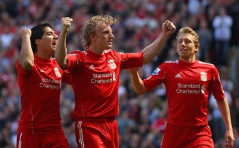 LIVERPOOL, ENGLAND - MAY 01:  Dirk Kuyt of Liverpool celebrates with team mates Luis Suarez and  Lucas after scoring the second goal from the penalty spot during the Barclays Premier League match between Liverpool  and Newcastle United at Anfield on May 1