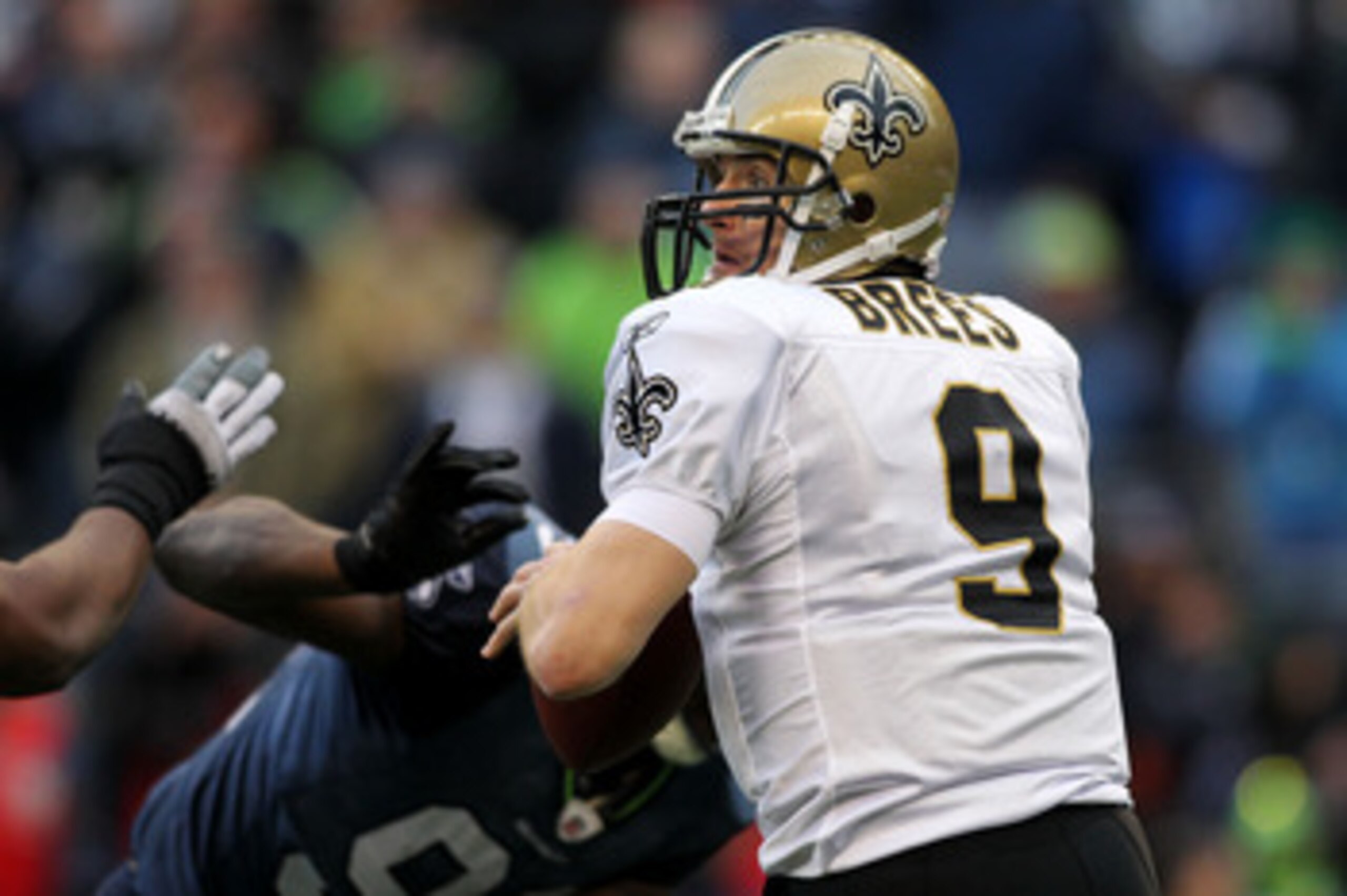 SEATTLE, WA - JANUARY 08:  Quarterback Drew Brees #9 of the New Orleans Saints scrambles against the Seattle Seahawks during the 2011 NFC wild-card playoff game at Qwest Field on January 8, 2011 in Seattle, Washington.  (Photo by Jonathan Ferrey/Getty Ima