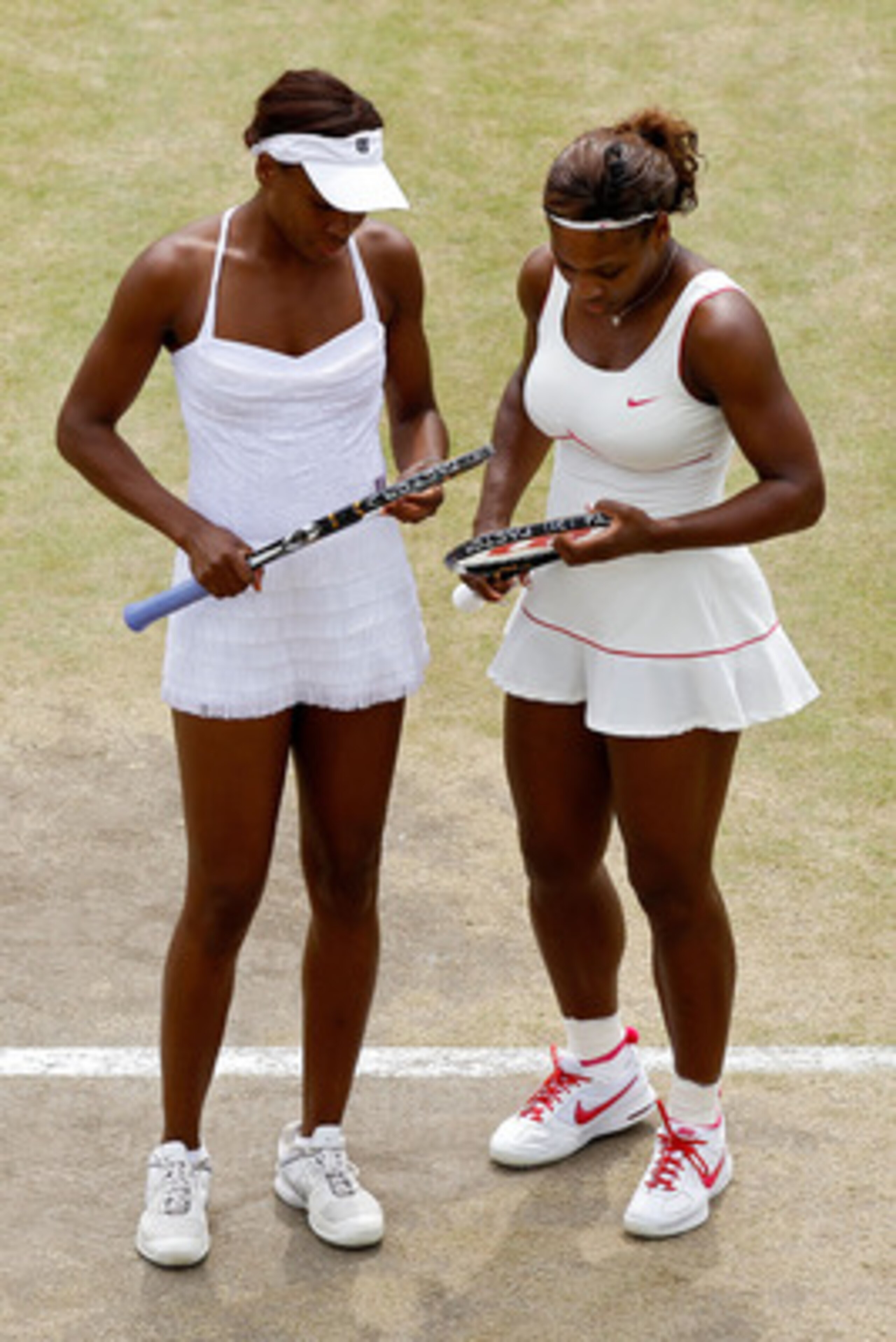LONDON, ENGLAND - JUNE 30:  Serena Williams (R) and Venus Williams of USA in action during their Quarter Final doubles match against Elena Vesnina and Vera Zvonareva of Russia on Day Nine of the Wimbledon Lawn Tennis Championships at the All England Lawn 