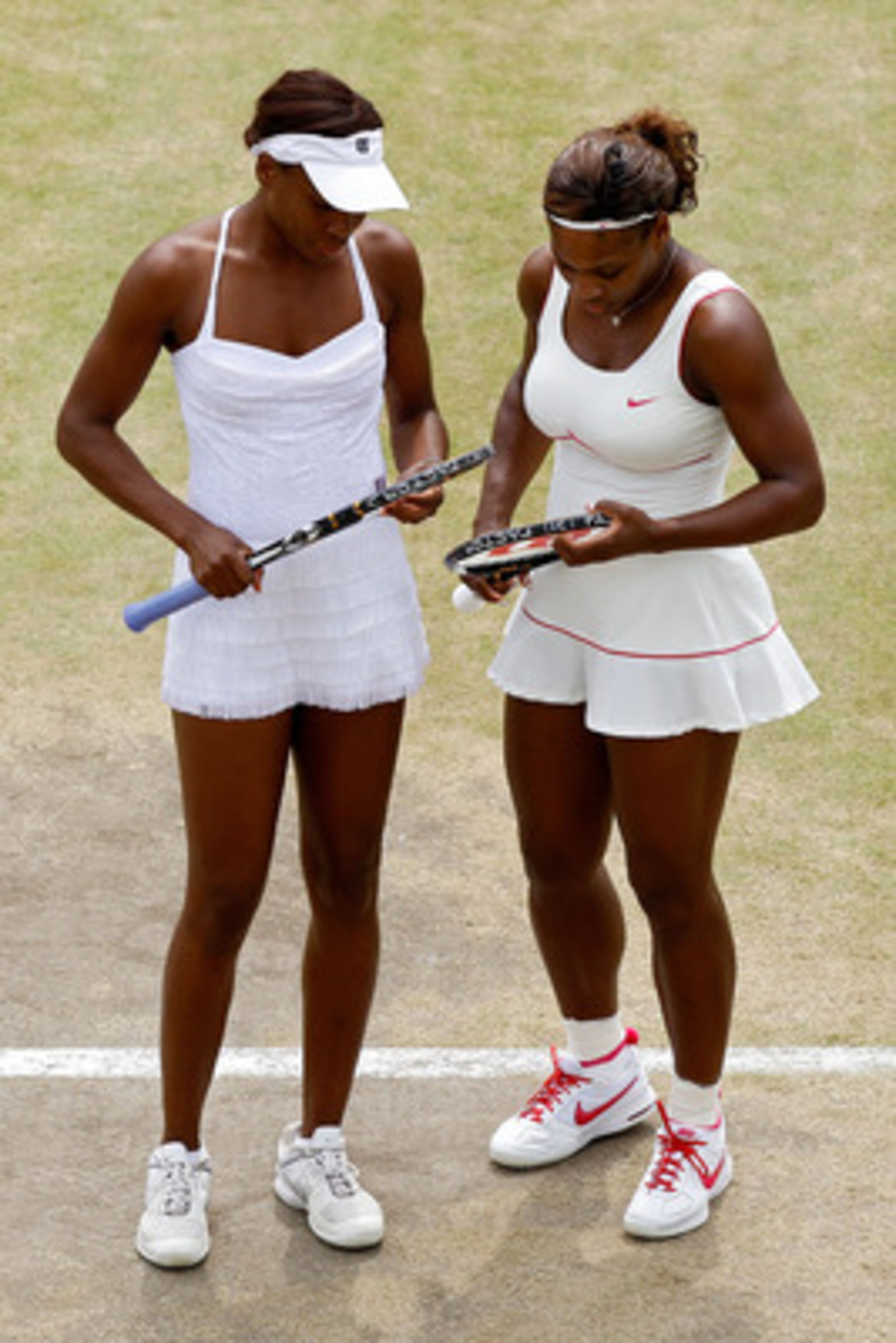LONDON, ENGLAND - JUNE 30:  Serena Williams (R) and Venus Williams of USA in action during their Quarter Final doubles match against Elena Vesnina and Vera Zvonareva of Russia on Day Nine of the Wimbledon Lawn Tennis Championships at the All England Lawn 