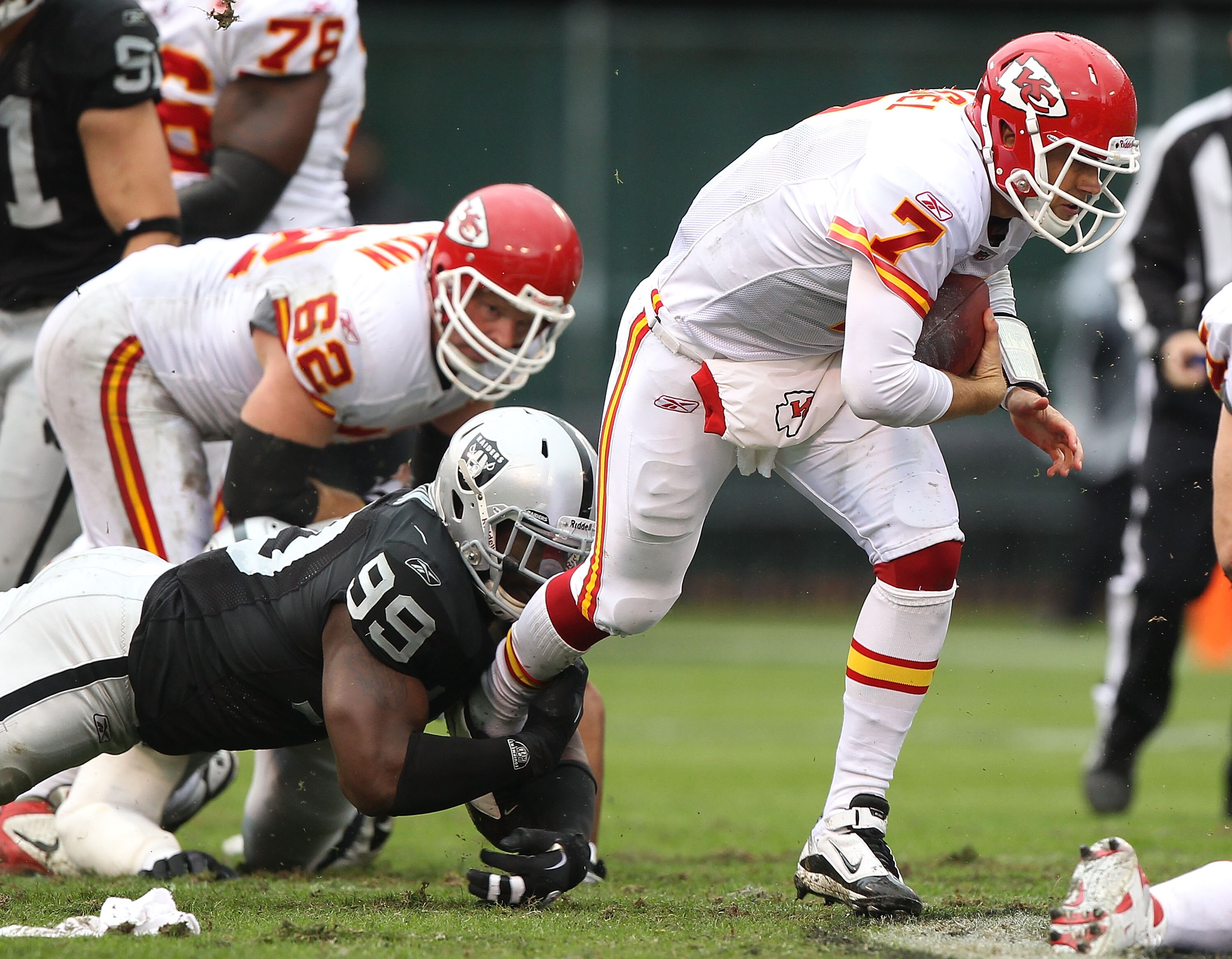 OAKLAND, CA - NOVEMBER 07:  Matt Cassel #7 of the Kansas City Chiefs runs with the ball against Lamarr Houston #99 of the Oakland Raiders during an NFL game at Oakland-Alameda County Coliseum on November 7, 2010 in Oakland, California.  (Photo by Jed Jaco