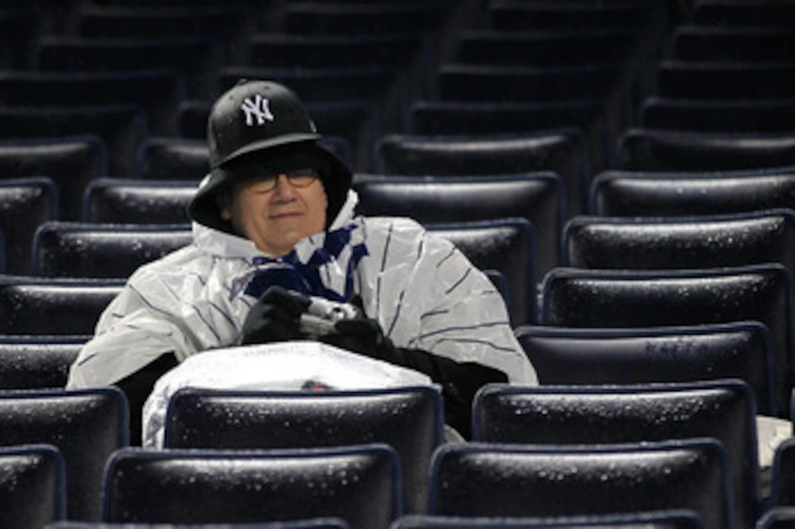 NEW YORK, NY - APRIL 06: Fans linger in their seats after the game between the Minnesota Twins and the New York Yankees is postponed due to weather at Yankee Stadium on April 6, 2011 in the Bronx borough of New York City.  (Photo by Chris Trotman/Getty Im