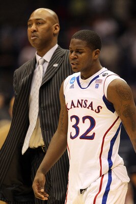 SAN ANTONIO, TX - MARCH 27:  Josh Selby #32 of the Kansas Jayhawks and assistant coach Danny Manning react after the southwest regional final of the 2011 NCAA men's basketball tournament against the Virginia Commonwealth Rams at the Alamodome on March 27,