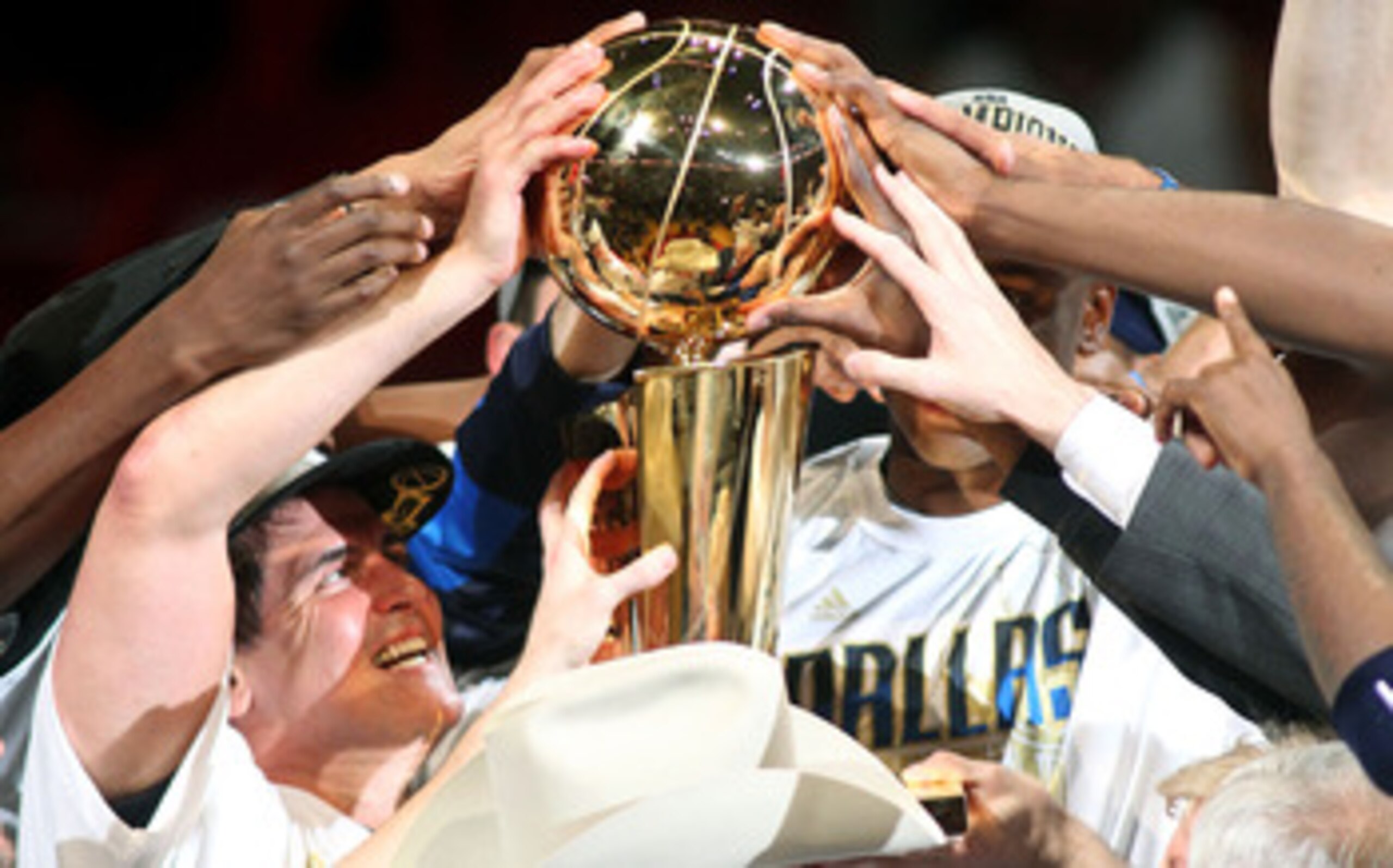 MIAMI, FL - JUNE 12:  Team owner Mark Cuban of the Dallas Mavericks celebrates with the Larry O'Brien trophy after the Mavericks won 105-95 against the Miami Heat in Game Six of the 2011 NBA Finals at American Airlines Arena on June 12, 2011 in Miami, Flo