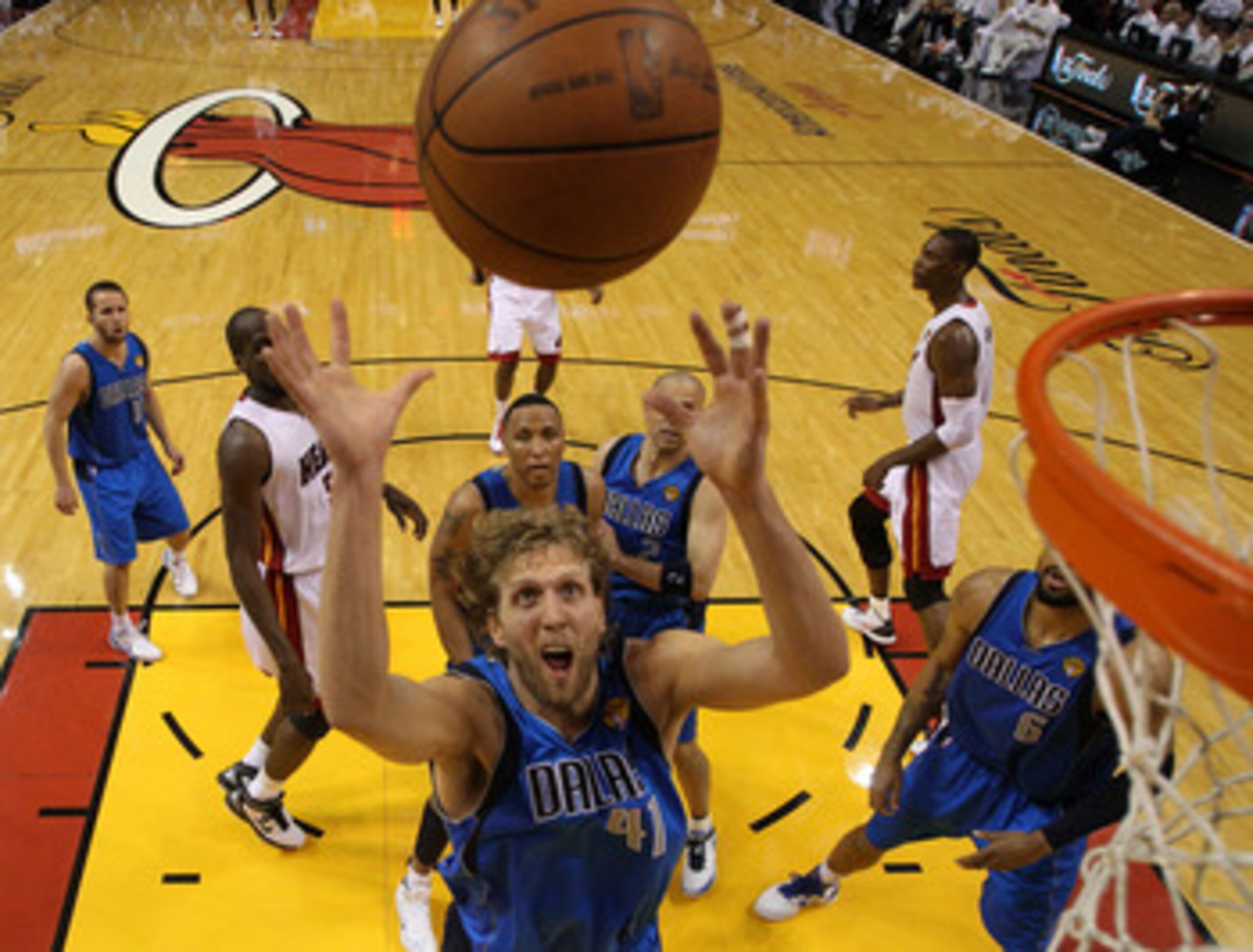 MIAMI, FL - JUNE 12:  Dirk Nowitzki #41 of the Dallas Mavericks reaches for a rebound against the Miami Heat in Game Six of the 2011 NBA Finals at American Airlines Arena on June 12, 2011 in Miami, Florida. NOTE TO USER: User expressly acknowledges and ag