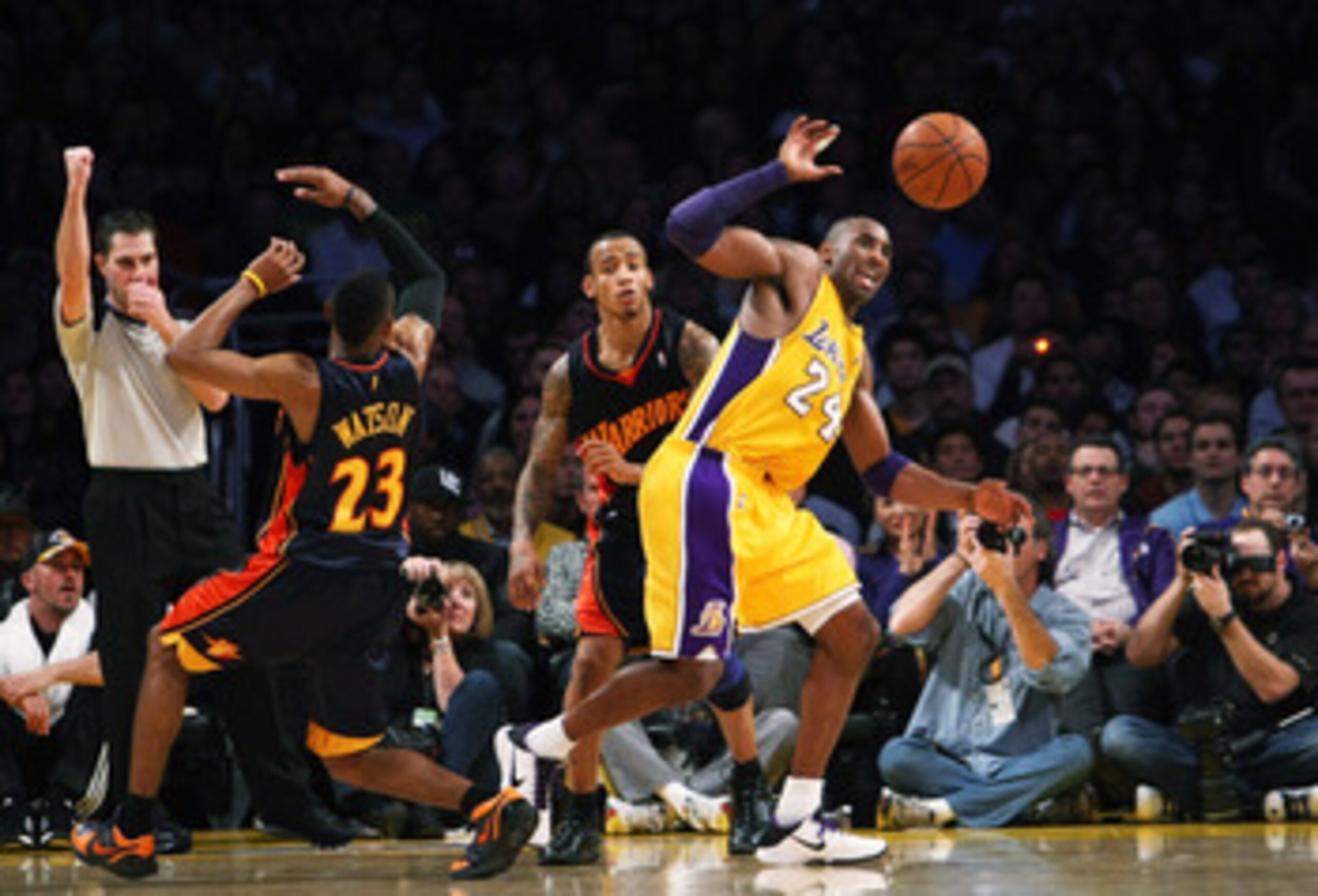 LOS ANGELES, CA - DECEMBER 29:  Kobe Bryant #24 of the Los Angeles Lakers goes for a loose ball in front of Monta Ellis #8 and C.J. Watson #23 of the Golden State Warriors on December 29, 2009 at Staples Center in Los Angeles, California.  The Lakers won 