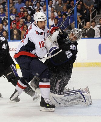 TAMPA, FL - MAY 04: Marco Sturm #18 of the Washington Capitals takes a goaltender interference penalty against Dwayne Roloson #35 of the Tampa Bay Lightning in Game Four of the Eastern Conference Semifinals during the 2011 NHL Stanley Cup Playoffs at the 