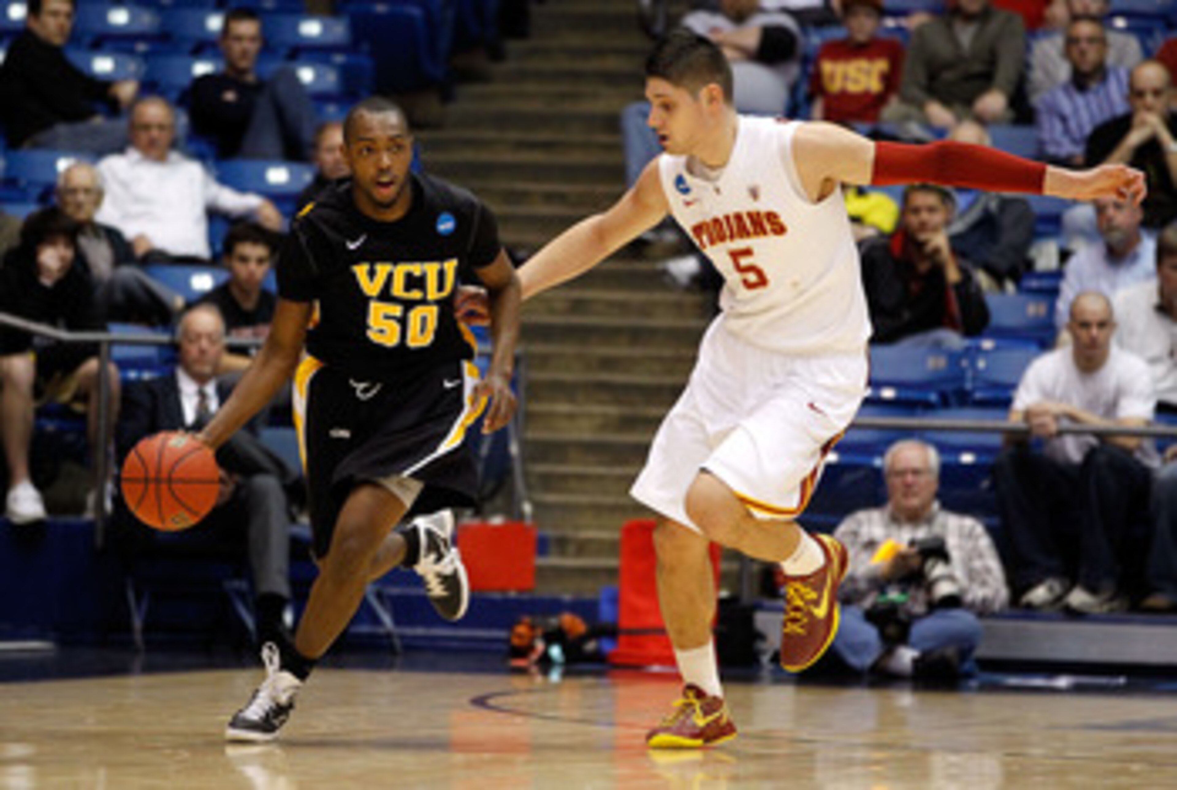 DAYTON, OH - MARCH 16: Ed Nixon #50 of the Virginia Commonwealth Rams dribbles the ball against Nikola Vucevic #5 of the USC Trojans during the first round of the 2011 NCAA men's basketball tournament at UD Arena on March 16, 2011 in Dayton, Ohio.  (Photo