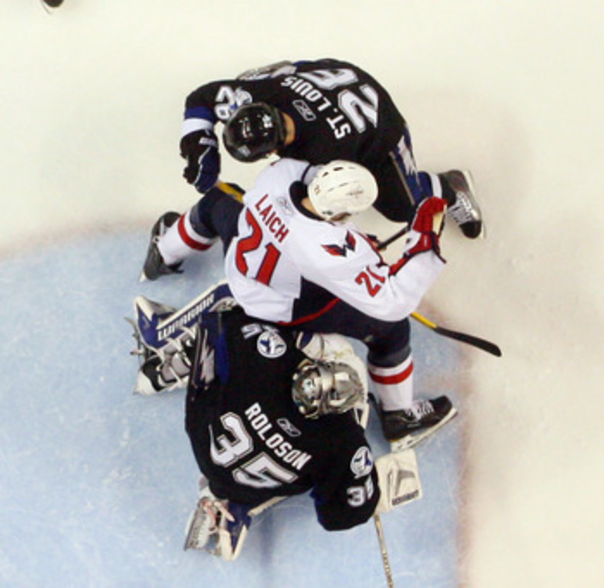 TAMPA, FL - MAY 03: Dwayne Roloson #35 and Martin St. Louis #26 of the Tampa Bay Lightning defend against Brooks Laich #21 of the Washington Capitals in Game Three of the Eastern Conference Semifinals during the 2011 NHL Stanley Cup Playoffs at St Pete Ti