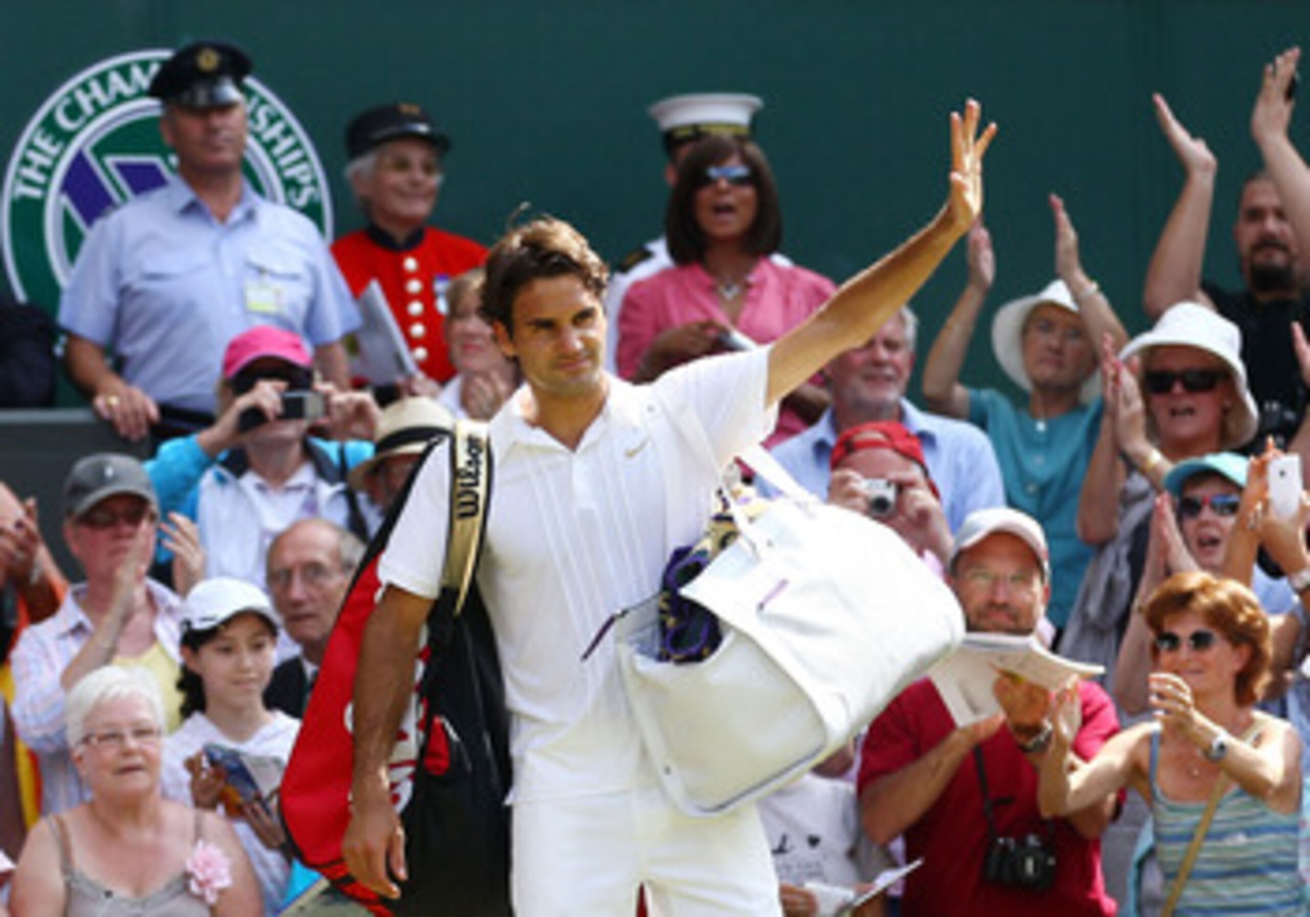 LONDON, ENGLAND - JUNE 30:  Roger Federer of Switzerland waves as he exits after losing his Quarter Final match against Tomas Berdych of Czech Republic on Day Nine of the Wimbledon Lawn Tennis Championships at the All England Lawn Tennis and Croquet Club 