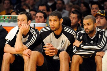 LOS ANGELES, CA - JANUARY 25:  (L-R) Manu Ginobili #20, Tim Duncan #21, and Tony Parker #9 of the San Antonio Spurs watch from the sidelines during the third quarter against the Los Angeles Lakers at the Staples Center on January 25, 2009 in Los Angeles,