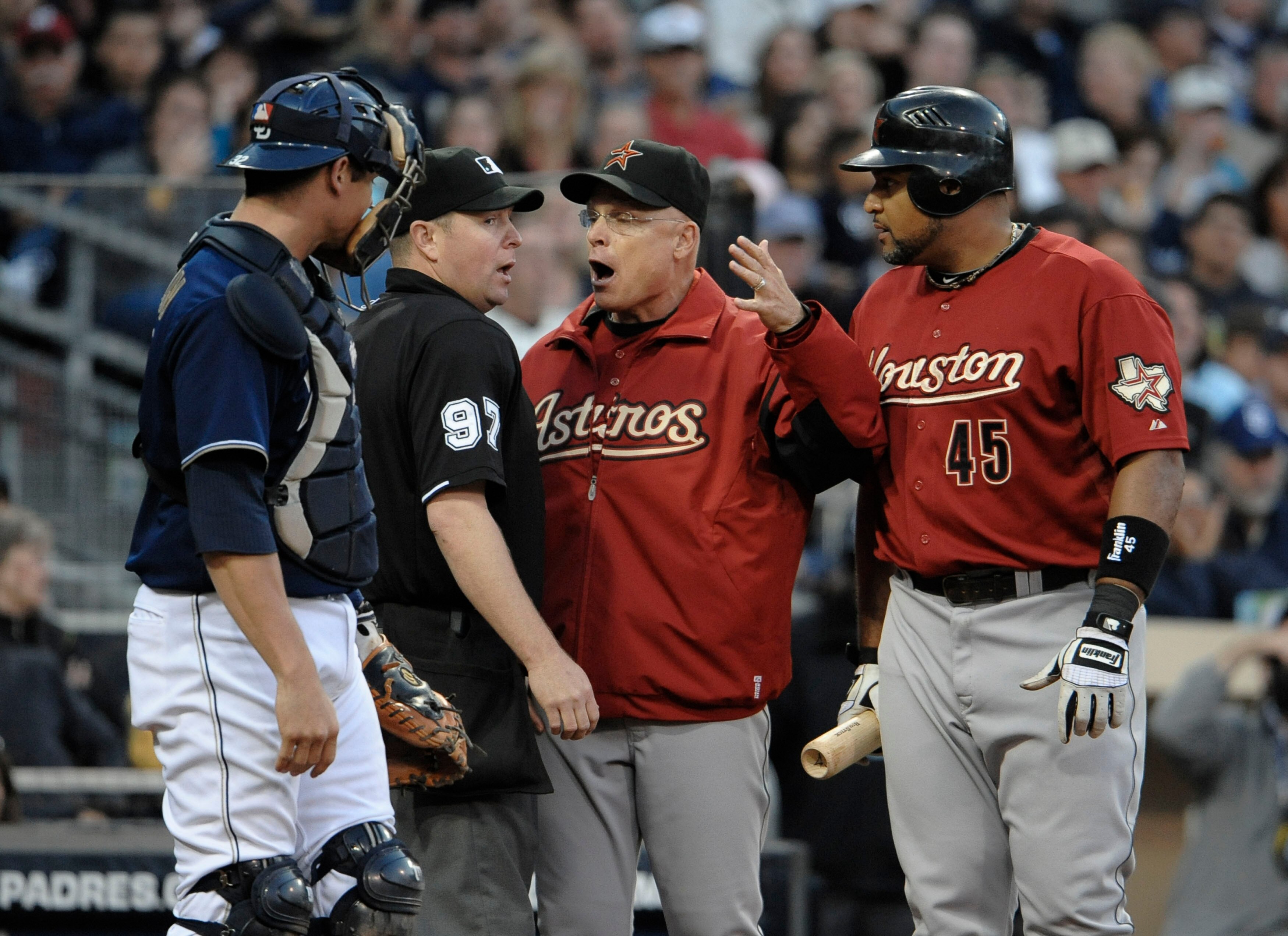 SAN DIEGO, CA - JUNE 4: Manager Brad Mills and Carlos Lee #45 of the Houston Astros argue a call with umpire Todd Tichenor as Rob Johnson #32 of the San Diego Padres looks on during the eighth inning of a baseball game at Petco Park on June 4, 2011 in San