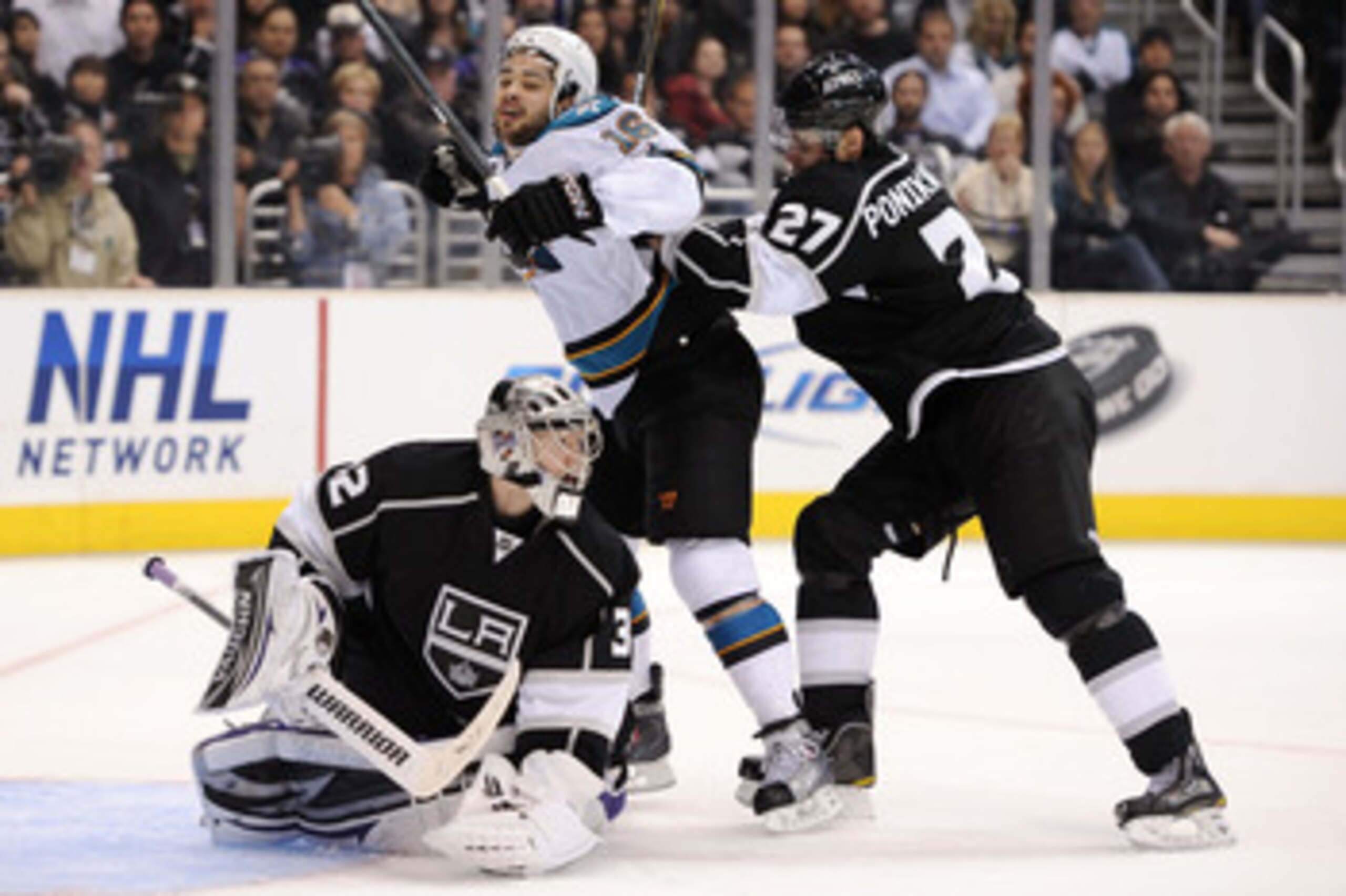 LOS ANGELES, CA - APRIL 21:  Devin Setoguchi #16 of the San Jose Sharks is hit by Alexei Ponikarovsky #27 of the Los Angeles Kings in game four of the Western Conference Quarterfinals during the 2011 NHL Stanley Cup Playoffs at Staples Center on April 21,