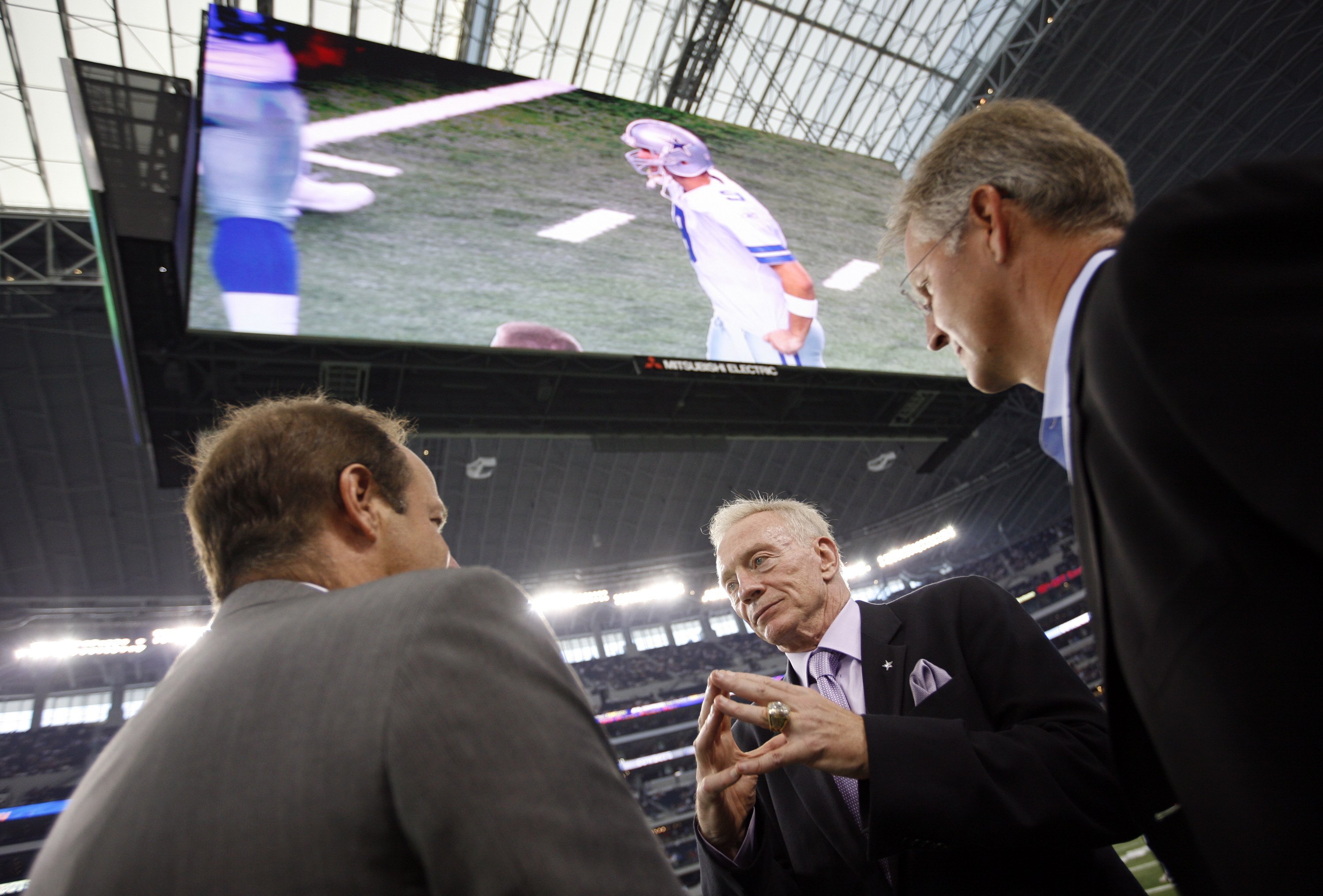 ARLINGTON, TX - AUGUST 21:  Dallas Cowboys team owner Jerry Jones (center) talks with two unidentified individuals prior to a preseason game at Dallas Cowboys Stadium on August 21, 2009 in Arlington, Texas. (Photo by Tom Pennington/Getty Images)