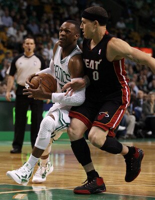 BOSTON, MA - MAY 09:  Rajon Rondo #9 of the Boston Celtics is tripped by Mike Bibby #0 of the Miami Heat in Game Four of the Eastern Conference Semifinals in the 2011 NBA Playoffs on May 9, 2011 at the TD Garden in Boston, Massachusetts.  NOTE TO USER: Us