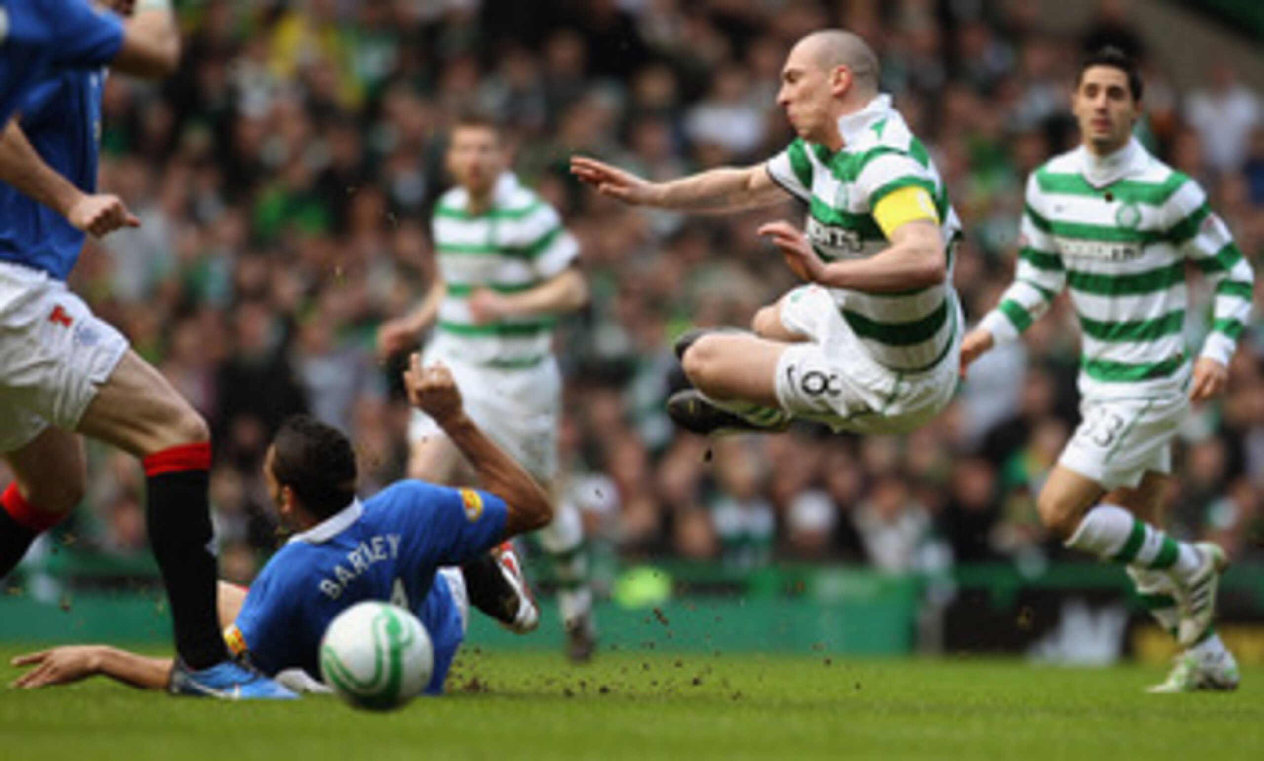 GLASGOW, SCOTLAND - FEBRUARY 20: Scott Brown of Celtic is tackled by Kyle Bartley of Rangers during the Clydesdale Bank Premier League match between Celtic and Rangers at Celtic Park on February 20, 2011 in Glasgow, Scotland.. (Photo by Jeff J Mitchell/ GLASGOW, SCOTLAND - FEBRUARY 20: Scott Brown of Celtic is tackled by Kyle Bartley of Rangers during the Clydesdale Bank Premier League match between Celtic and Rangers at Celtic Park on February 20, 2011 in Glasgow, Scotland.. (Photo by Jeff J Mitchell/
