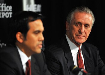 MIAMI - JULY 09:  Head coach Erik Spoelstra (L) and President Pat Riley (R)  of the Miami Heat talk during a press conference after a welcome party for new teammates LeBron James, Dwyane Wade, and Chris Bosh at American Airlines Arena on July 9, 2010 in M