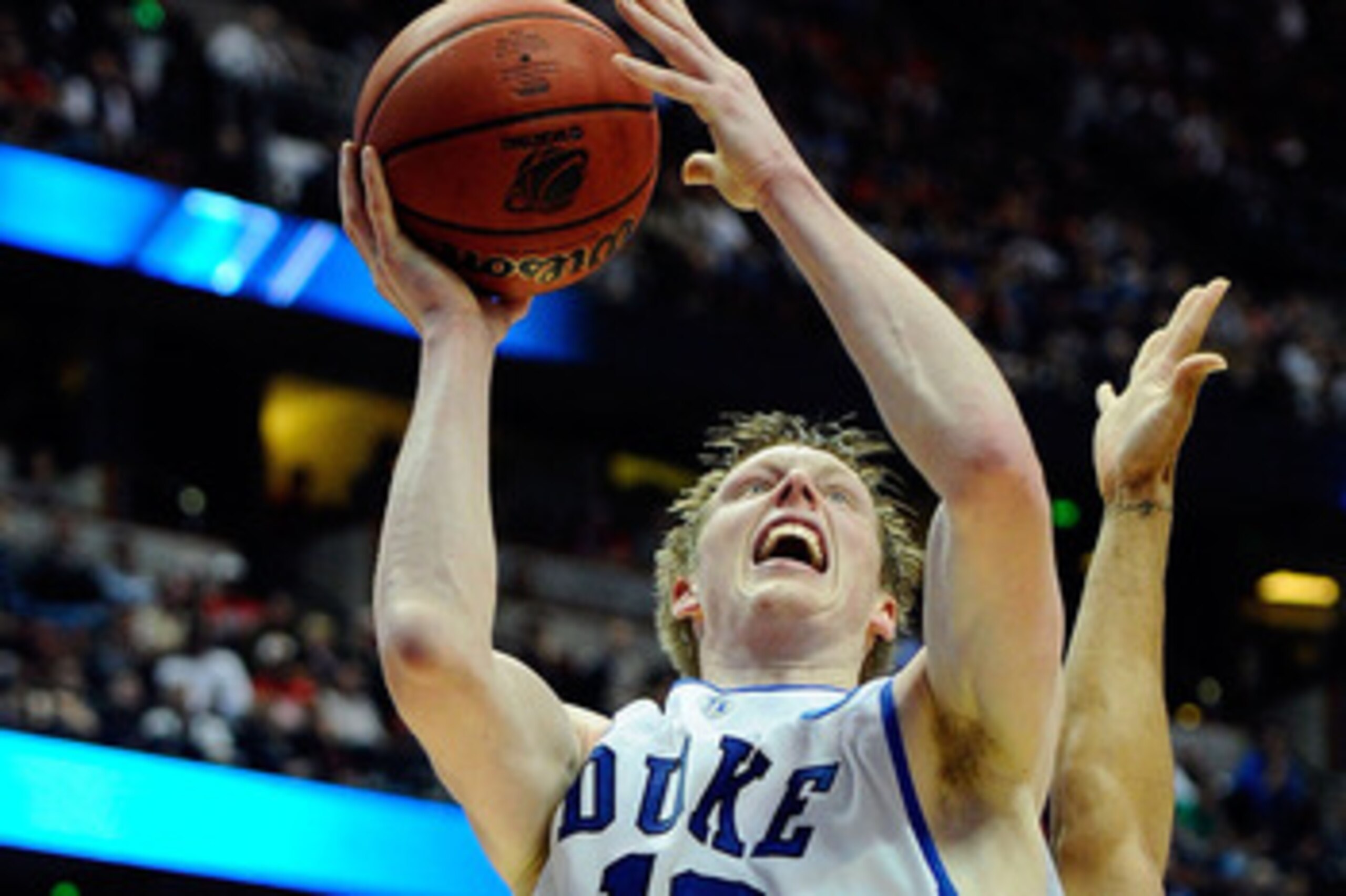ANAHEIM, CA - MARCH 24:  Kyle Singler #12 of the Duke Blue Devils goes to the basket against Jamelle Horne #42 of the Arizona Wildcats during the west regional semifinal of the 2011 NCAA men's basketball tournament at the Honda Center on March 24, 2011 in