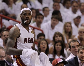 MIAMI, FL - JUNE 12:  LeBron James #6 of the Miami Heat sits on the scorer's table against the Dallas Mavericks in Game Six of the 2011 NBA Finals at American Airlines Arena on June 12, 2011 in Miami, Florida. NOTE TO USER: User expressly acknowledges and