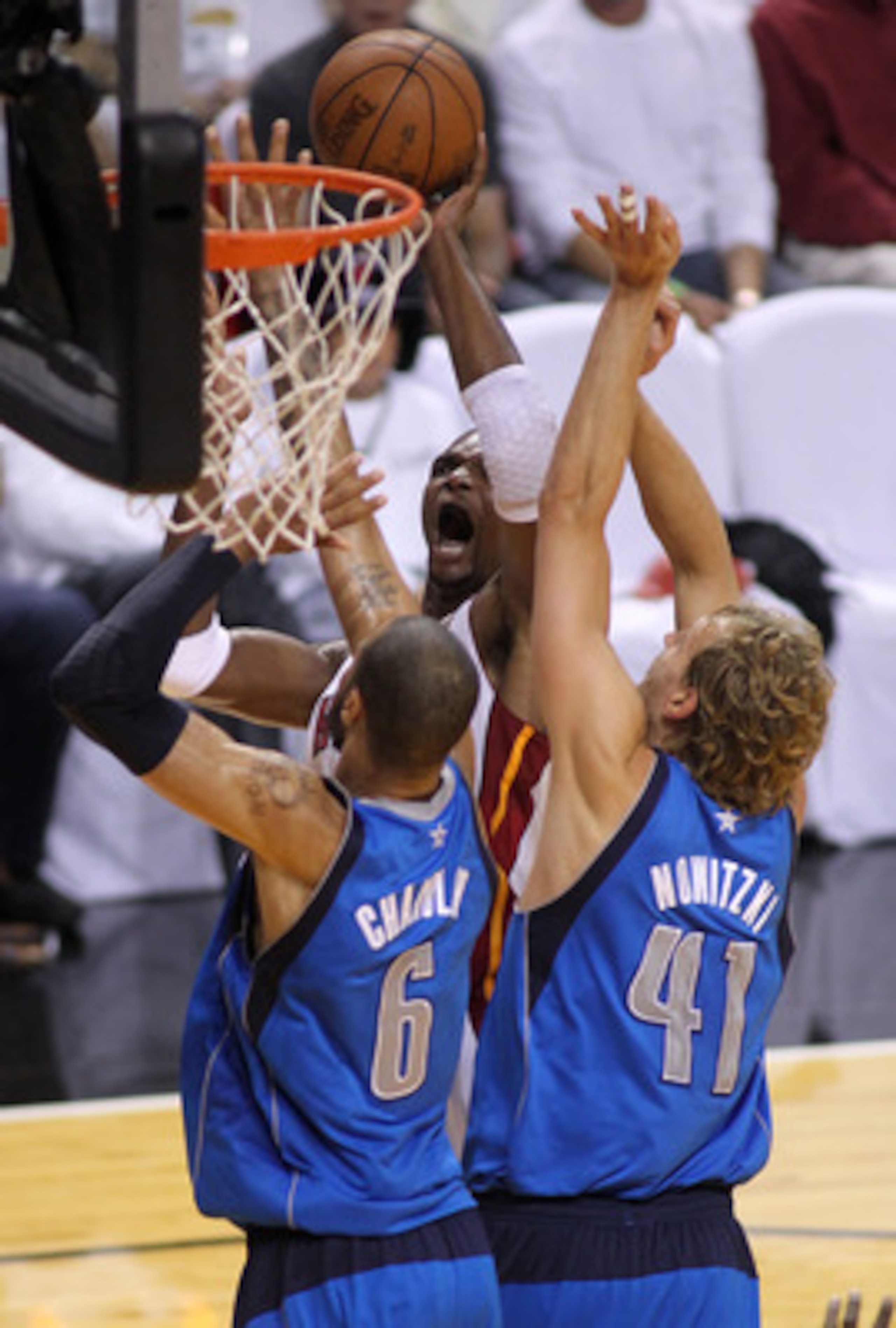 MIAMI, FL - JUNE 12:  Chris Bosh #1 of the Miami Heat attempts a shot against Tyson Chandler #6 and Dirk Nowitzki #41 of the Dallas Mavericks in Game Six of the 2011 NBA Finals at American Airlines Arena on June 12, 2011 in Miami, Florida. NOTE TO USER: U