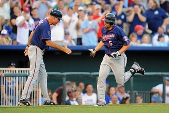 KANSAS CITY, MO - JUNE 3: Michael Cuddyer #5 of the Minnesota Twins is greeted by third base coach Steve Liddle #9 after hitting a solo home run against the Kansas City Royals in the third inning at Kauffman Stadium on June 3, 2011 in Kansas City, Missour