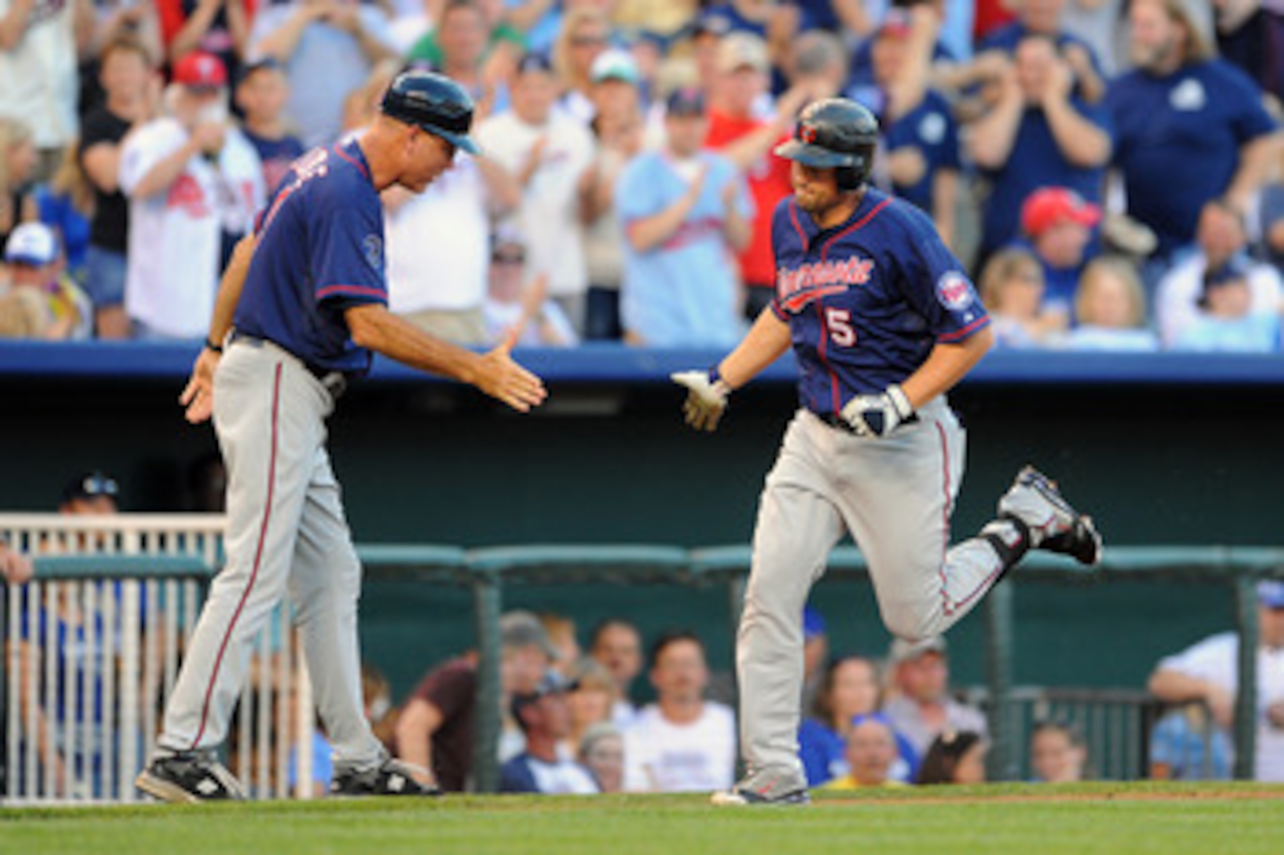 KANSAS CITY, MO - JUNE 3: Michael Cuddyer #5 of the Minnesota Twins is greeted by third base coach Steve Liddle #9 after hitting a solo home run against the Kansas City Royals in the third inning at Kauffman Stadium on June 3, 2011 in Kansas City, Missour KANSAS CITY, MO - JUNE 3: Michael Cuddyer #5 of the Minnesota Twins is greeted by third base coach Steve Liddle #9 after hitting a solo home run against the Kansas City Royals in the third inning at Kauffman Stadium on June 3, 2011 in Kansas City, Missour
