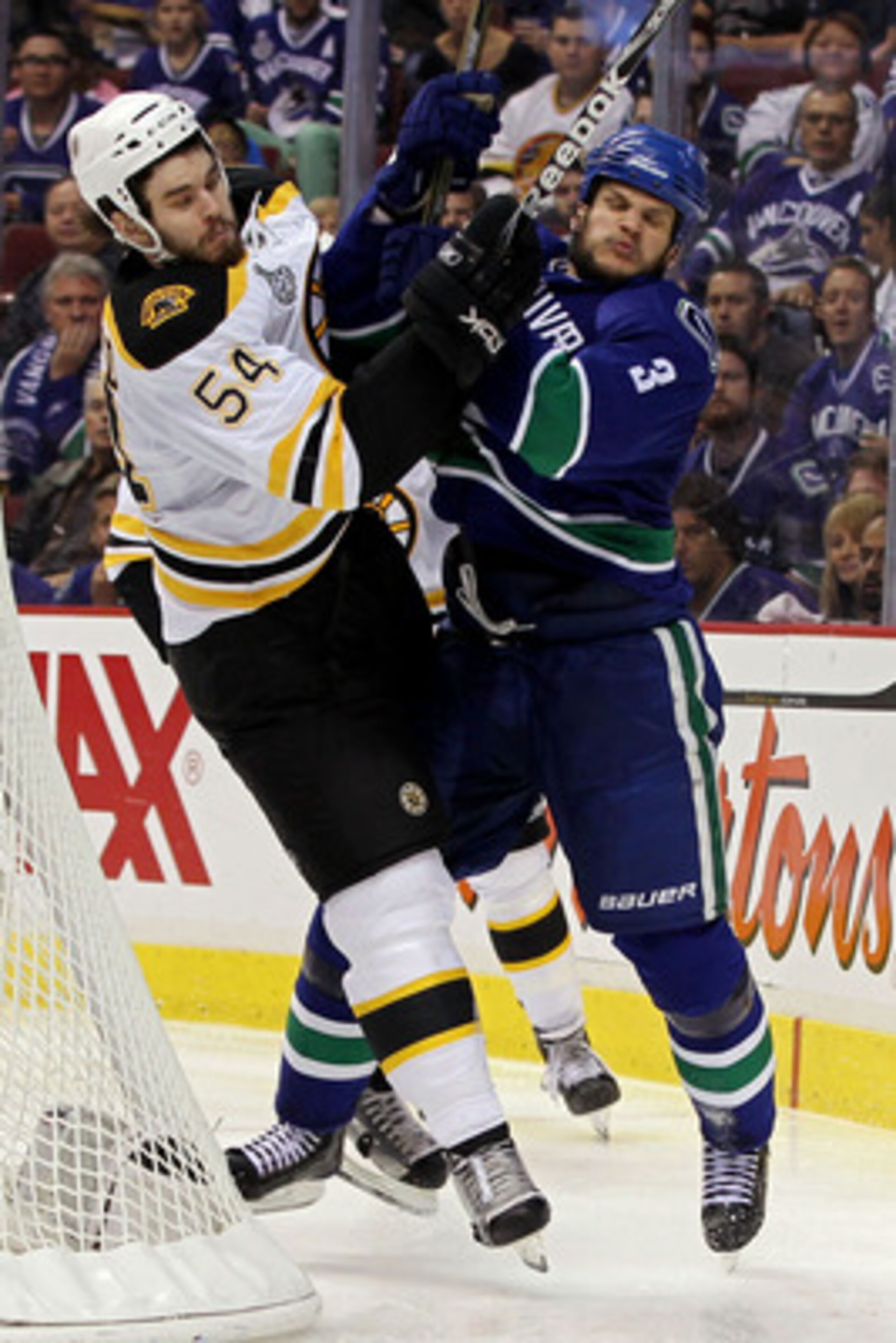 VANCOUVER, BC - JUNE 10:  Adam McQuaid #54 of the Boston Bruins collides with Kevin Bieksa #3 of the Vancouver Canucks during Game Five of the 2011 NHL Stanley Cup Final at Rogers Arena on June 10, 2011 in Vancouver, British Columbia, Canada.  (Photo by B