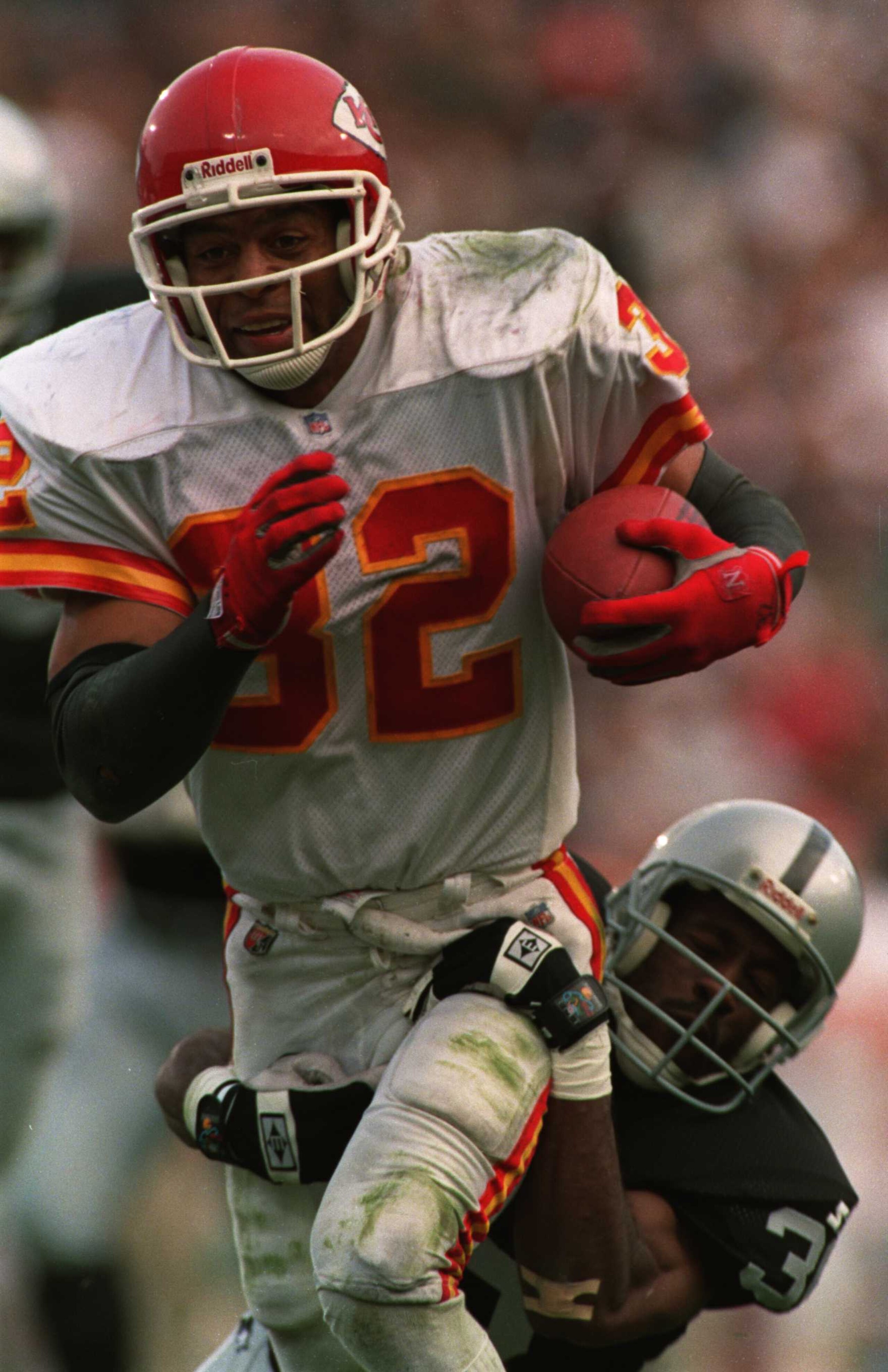 3 DEC 1995: RUNNINGBACK MARCUS ALLEN OF THE KANSAS CITY CHIEFS IS WRAPPED UP BY TERRY MCDANIEL OF THE OAKLAND RAIDERS DURING THE FOURTH QUARTER OF THE CHIEF''S 29-23 WIN AT OAKLAND COLISEUM IN OAKLAND, CALIFORNIA. THE CHIEFS CLINCHED THE AFC WEST WITH THE