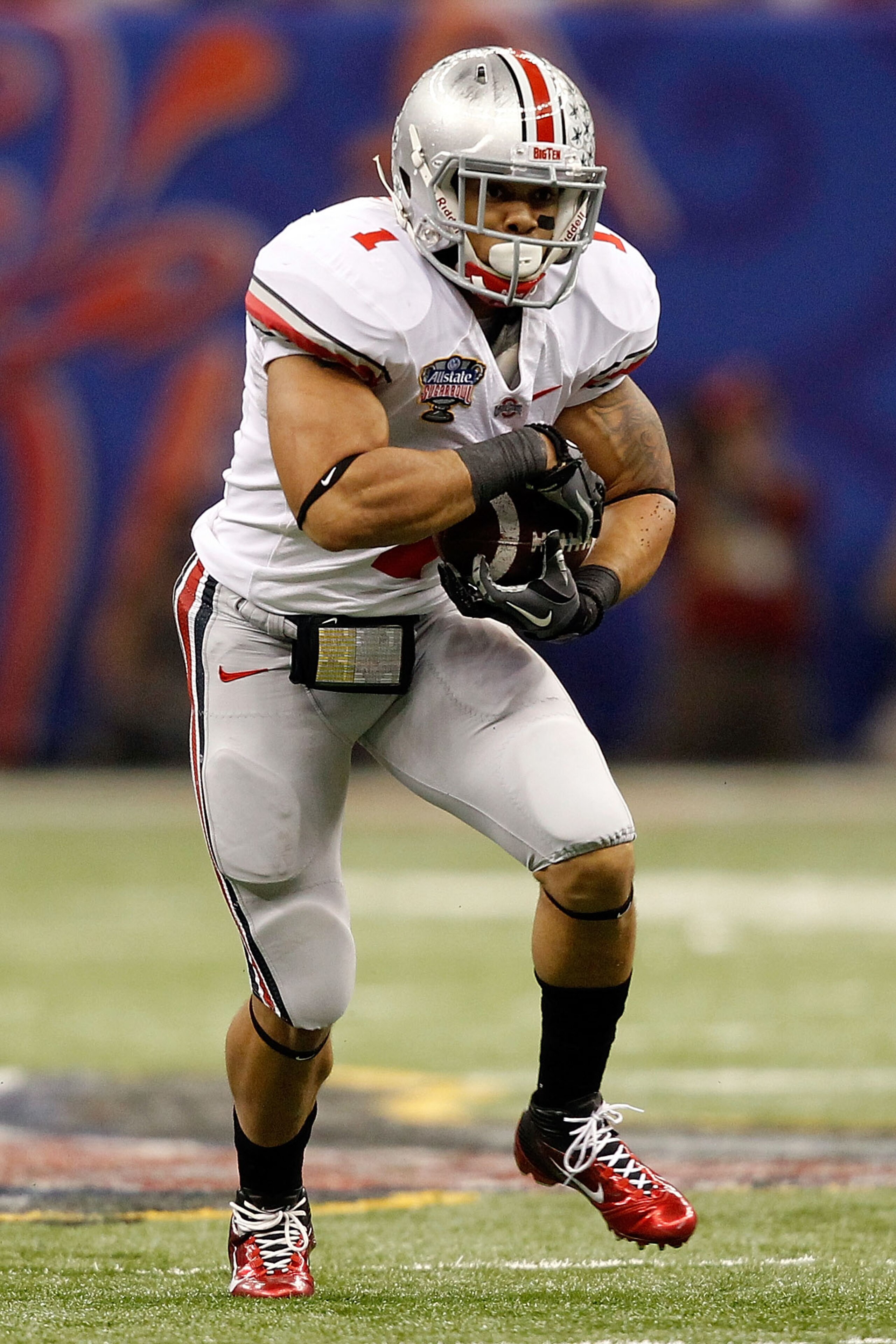 NEW ORLEANS, LA - JANUARY 04:  Dan Herron #1 of the Ohio State Buckeyes runs the ball against the Arkansas Razorbacks during the Allstate Sugar Bowl at the Louisiana Superdome on January 4, 2011 in New Orleans, Louisiana.  (Photo by Matthew Stockman/Getty