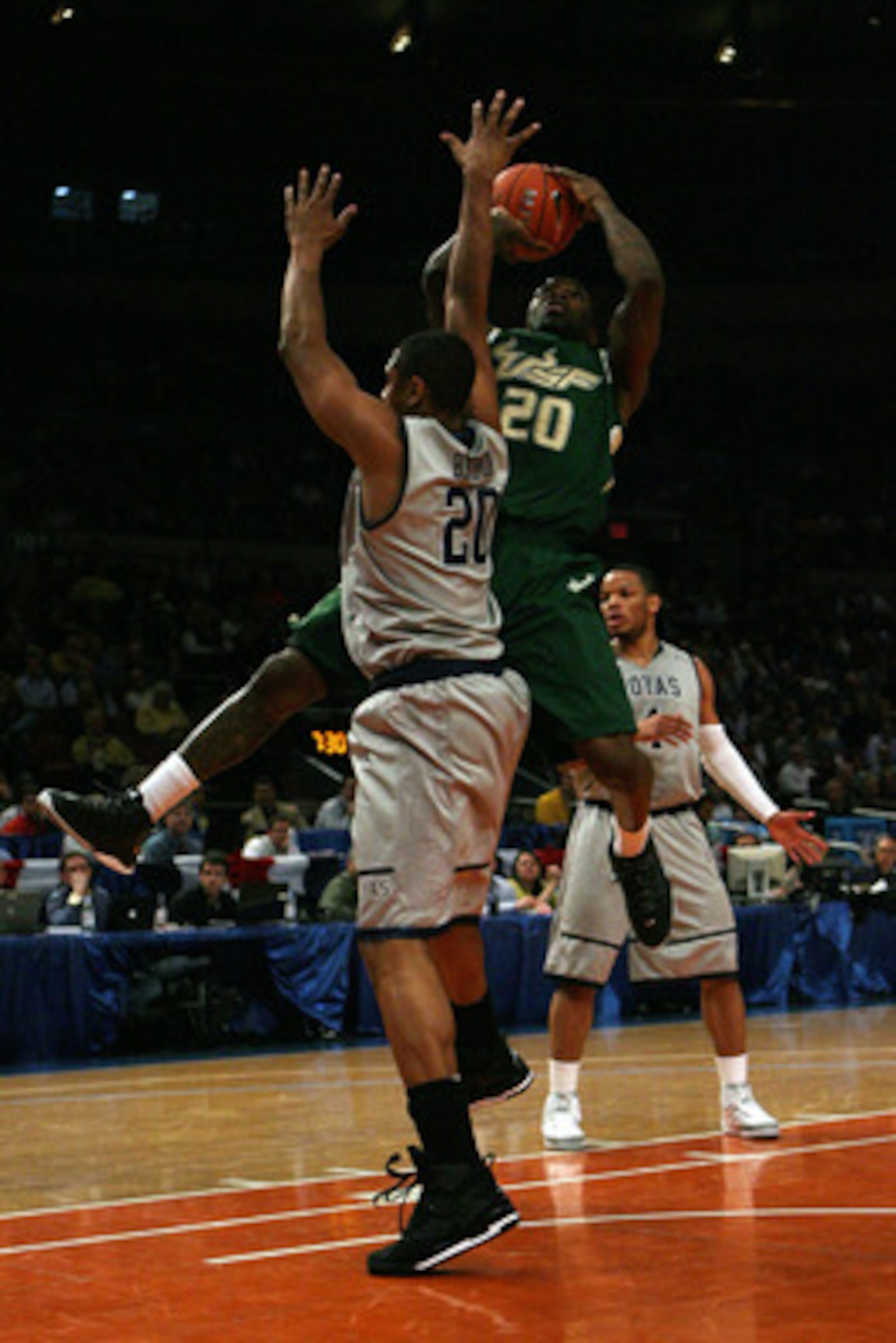 NEW YORK - MARCH 10:  Dominique Jones #20 of the USF Bulls goes to the hoop against Jerrelle Benimon #20 of the Georgetown Hoyas during the second round of 2010 NCAA Big East Tournament at Madison Square Garden on March 10, 2010 in New York City.  (Photo