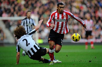 SUNDERLAND, ENGLAND - JANUARY 16:  Newcastle player Fabricio Coloccini fails to stop Ahmed Elmohamady of Sunderland during the Barclays Premier League match between Sunderland and Newcastle United at Stadium of Light on January 16, 2011 in Sunderland, Eng