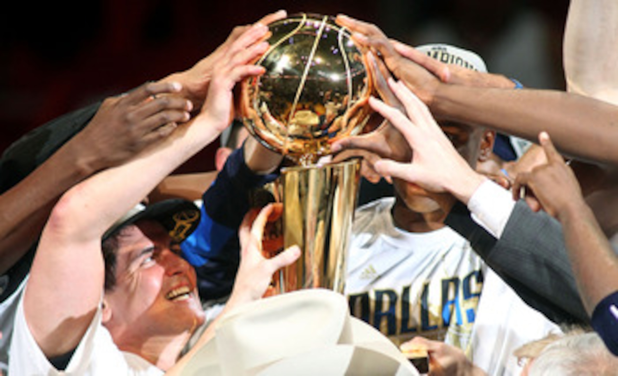 MIAMI, FL - JUNE 12: Team owner Mark Cuban of the Dallas Mavericks celebrates with the Larry O'Brien trophy after the Mavericks won 105-95 against the Miami Heat in Game Six of the 2011 NBA Finals at American Airlines Arena on June 12, 2011 in Miami, Flo MIAMI, FL - JUNE 12: Team owner Mark Cuban of the Dallas Mavericks celebrates with the Larry O'Brien trophy after the Mavericks won 105-95 against the Miami Heat in Game Six of the 2011 NBA Finals at American Airlines Arena on June 12, 2011 in Miami, Flo