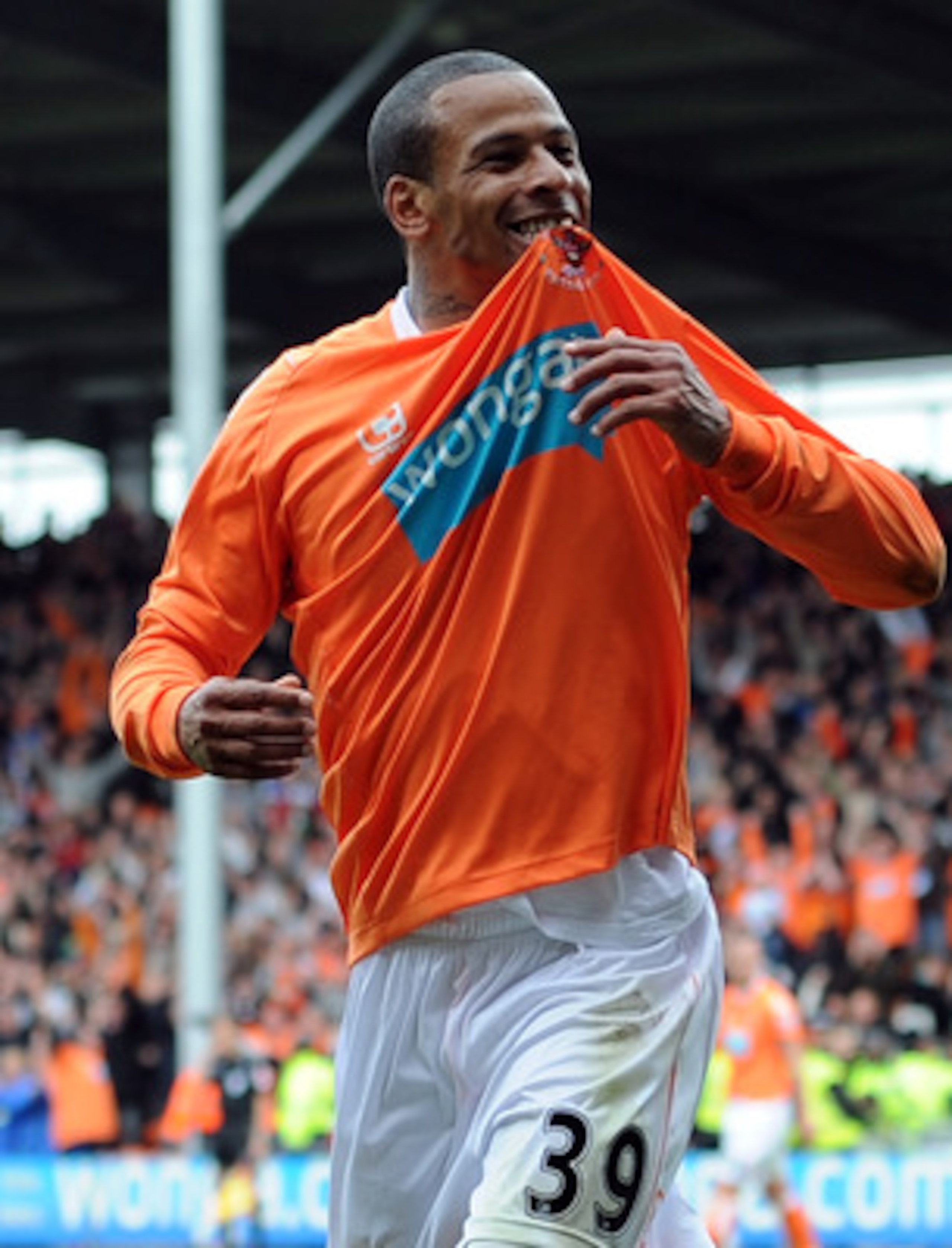BLACKPOOL, ENGLAND - MAY 14:  DJ Campbell of Blackpool celebrates after scoring his side's third goal during the Barclays Premier League match between Blackpool and Bolton Wanderers at Bloomfield Road on May 14, 2011 in Blackpool, England.  (Photo by Chri
