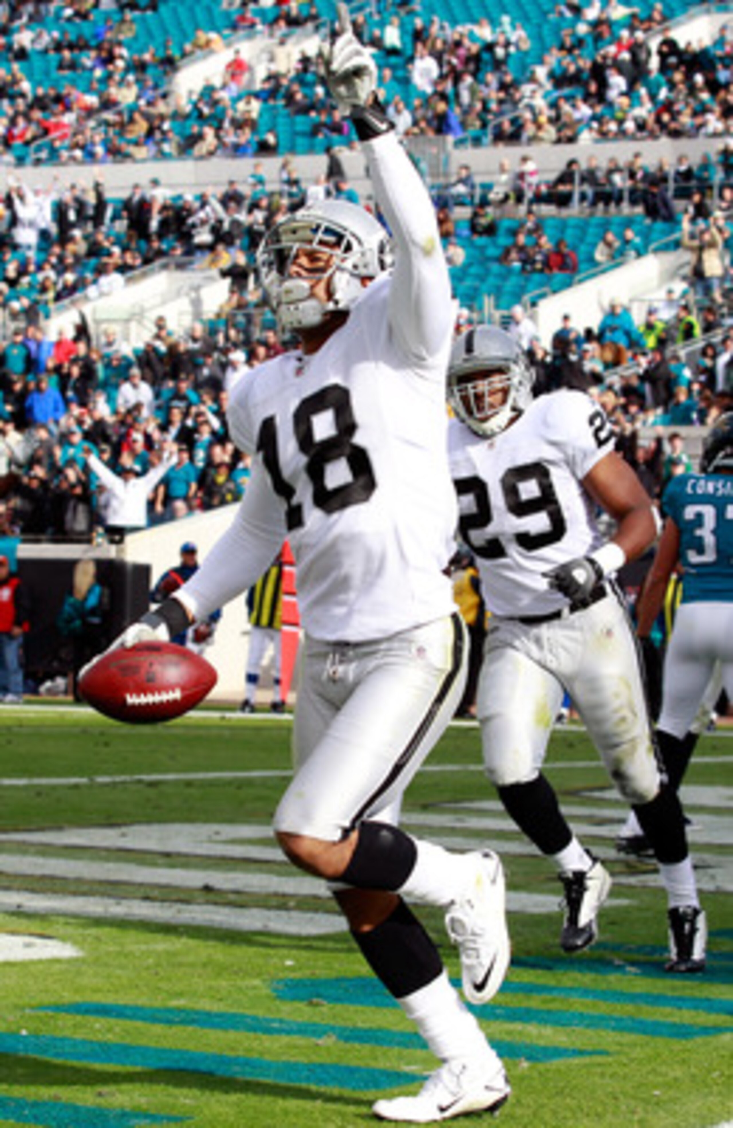 JACKSONVILLE, FL - DECEMBER 12:  Louis Murphy #18 of the Oakland Raiders celebrates a touchdown during the game against the Jacksonville Jaguars at EverBank Field on December 12, 2010 in Jacksonville, Florida.  (Photo by Sam Greenwood/Getty Images)