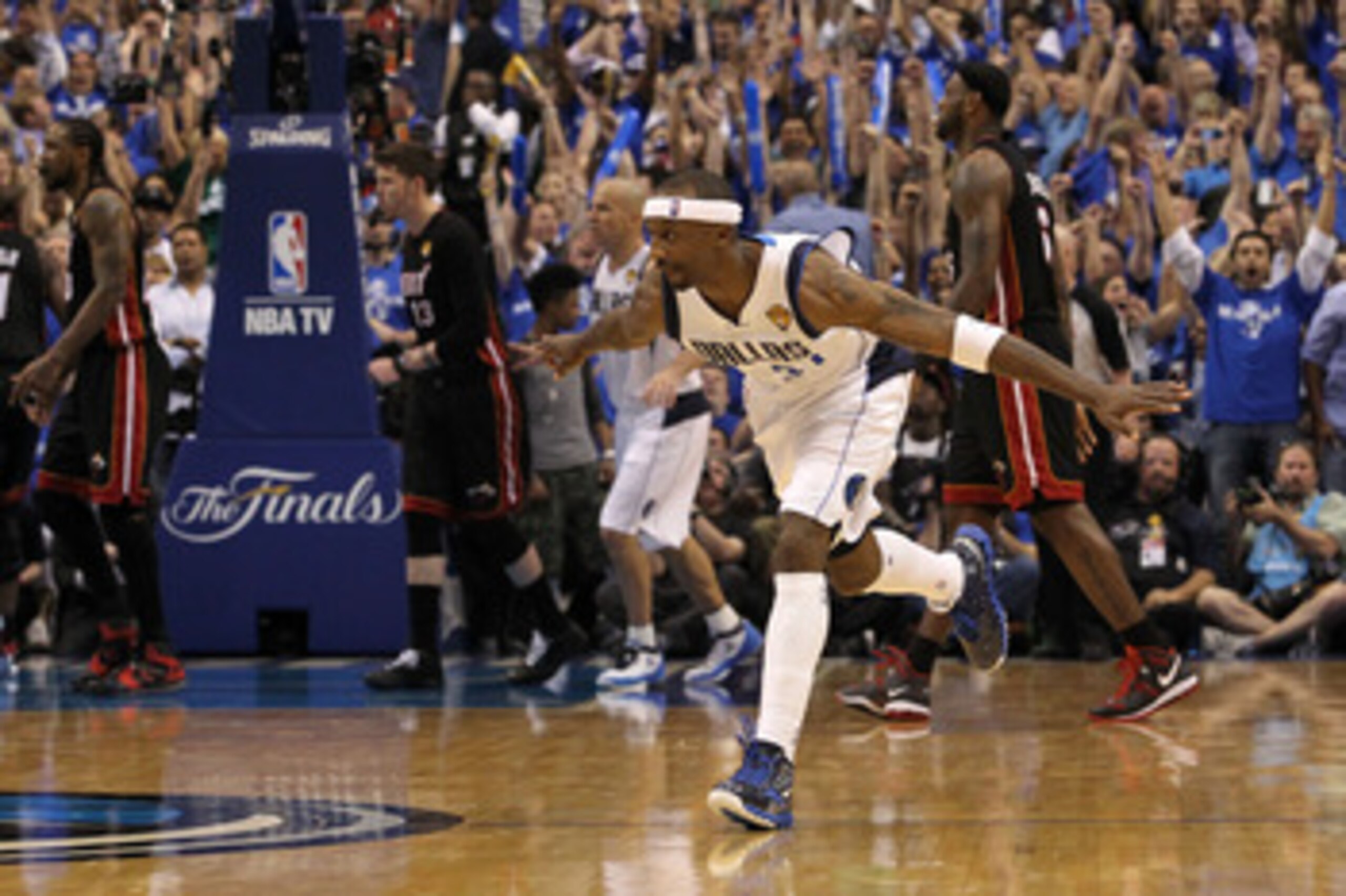 DALLAS, TX - JUNE 09:  Jason Terry #31 of the Dallas Mavericks reacts after he made a 3-point shot late in the fourth quarter as Udonis Haslem #40 (L), Mike Miller #13 and LeBron James #6 of the Miami Heat walk towards their bench in Game Five of the 2011