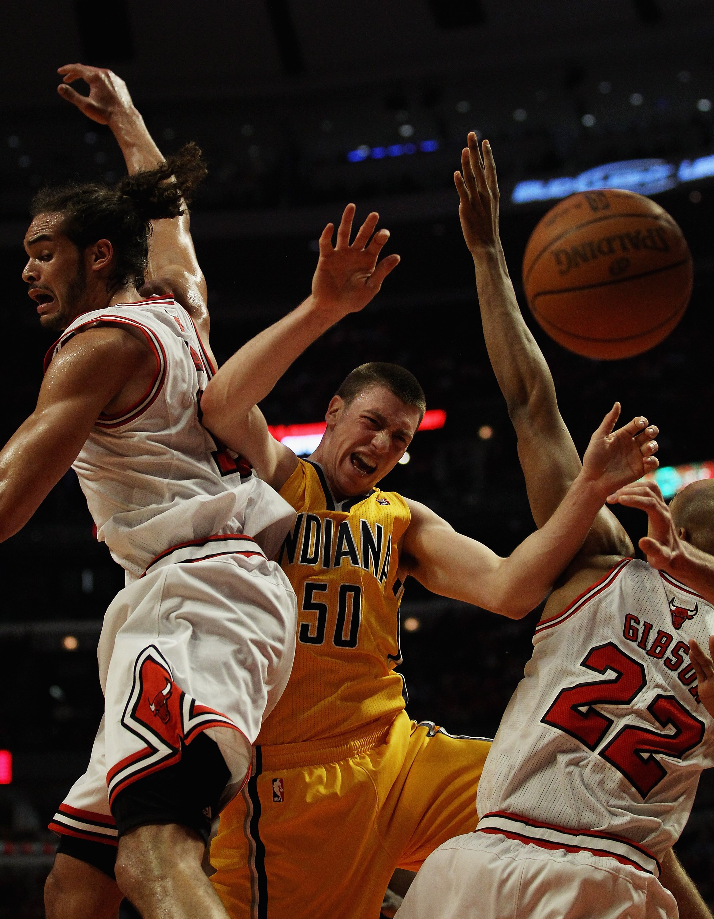 CHICAGO, IL - APRIL 26: Tyler Hansbrough #50 of the Indiana Pacers looses control of the ball under pressure from Joakim Noah #13 and Taj Gibson #22 of the Chicago Bulls in Game Five of the Eastern Conference Quarterfinals in the 2011 NBA Playoffs at the
