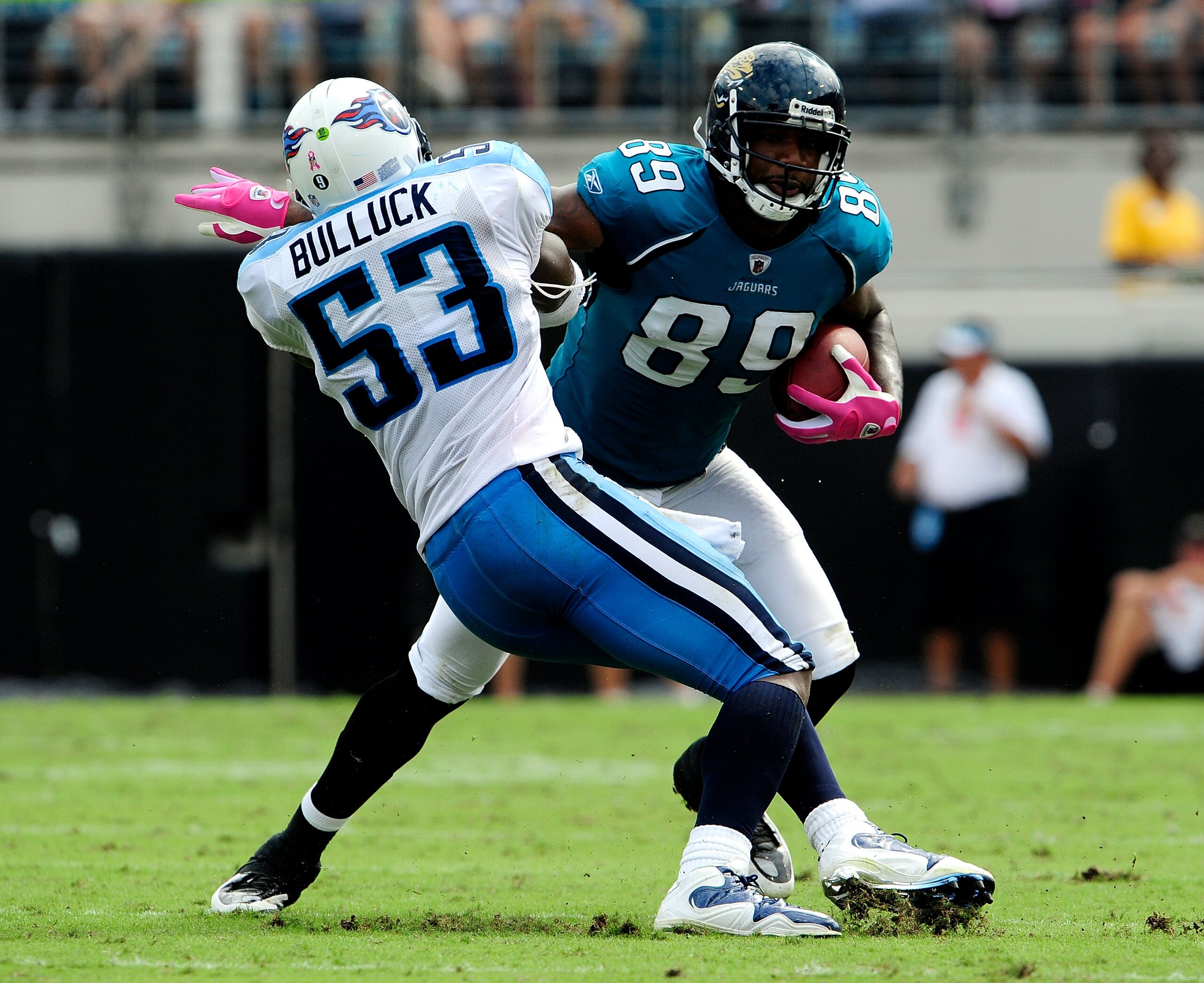 JACKSONVILLE, FL - OCTOBER 04:  Marcedes Lewis #89 of the Jacksonville Jaguars is tackled by Keith Bullock #53 of the Tennessee Titans during the game at Jacksonville Municipal Stadium on October 4, 2009 in Jacksonville, Florida.  (Photo by Sam Greenwood/
