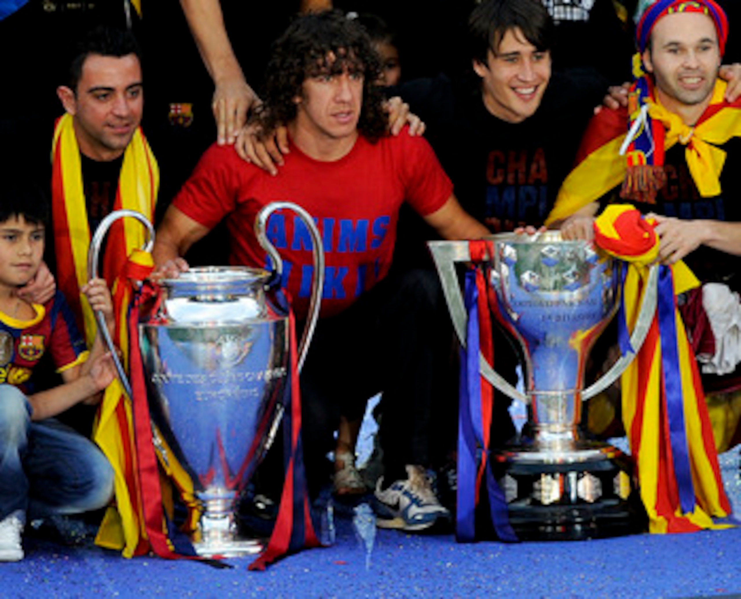 BARCELONA, SPAIN - MAY 29:  FC Barcelona players pose with the La Liga Tropy and the UEFA Champions League trophy during the celebrations after winning the UEFA Champions League Final against Manchester United at Camp Nou Stadium on May 29, 2011 in Barcel
