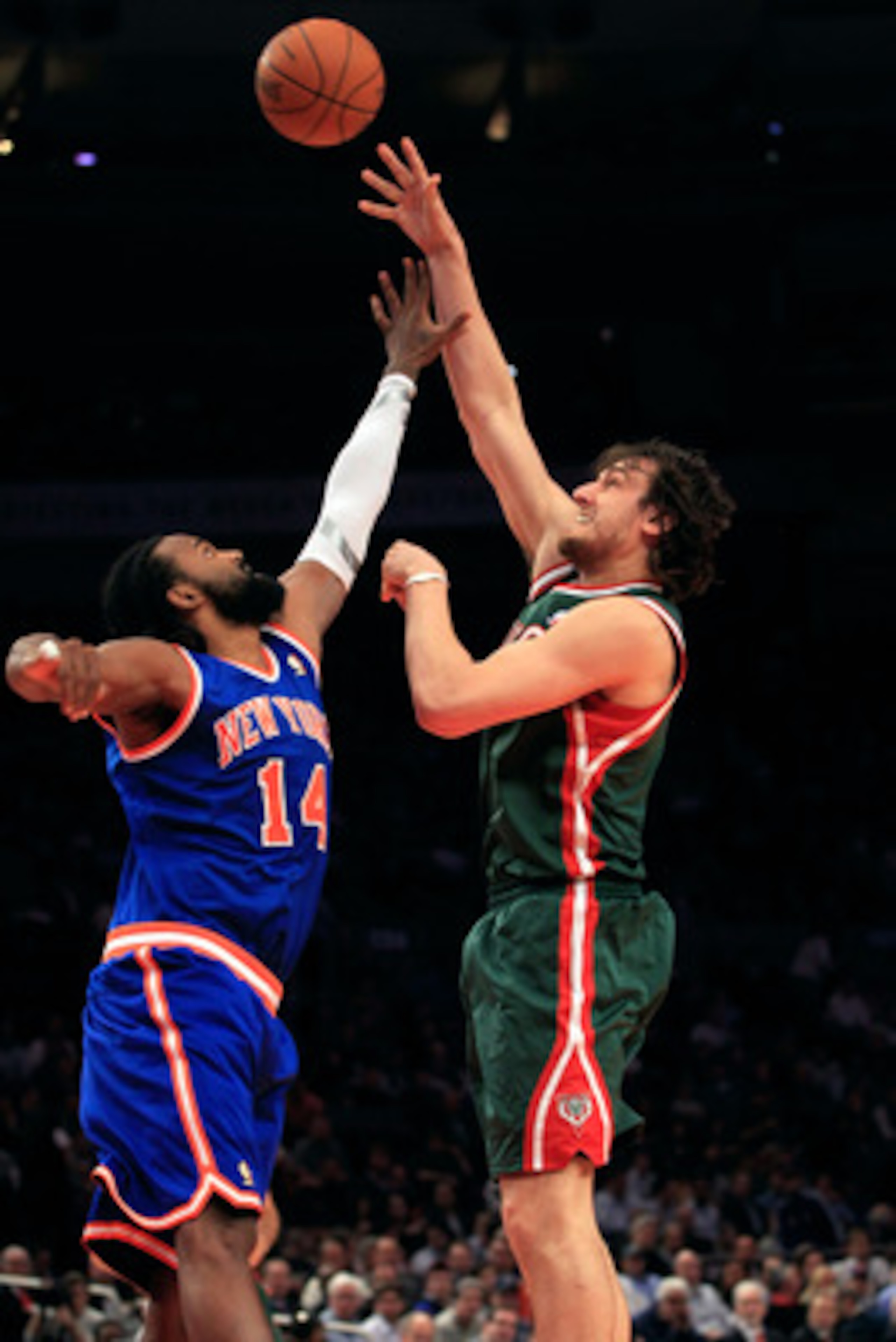 NEW YORK, NY - FEBRUARY 23: Andrew Bogut #6 of the Milwaukee Bucks shoots the ball over Ronny Turiaf #14 of the New York Knicks at Madison Square Garden on February 23, 2011 in New York City. NOTE TO USER: User expressly acknowledges and agrees that, by NEW YORK, NY - FEBRUARY 23: Andrew Bogut #6 of the Milwaukee Bucks shoots the ball over Ronny Turiaf #14 of the New York Knicks at Madison Square Garden on February 23, 2011 in New York City. NOTE TO USER: User expressly acknowledges and agrees that, by